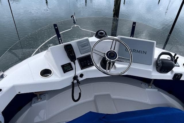 Cockpit of 2021 Ranger Tugs R-31 CB with Garmin navigation system and steering wheel.