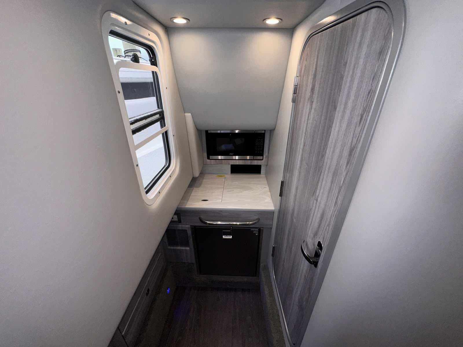 Interior of 2025 Formula 350 Crossover Bowrider I/O, featuring modern kitchenette and sleek design.