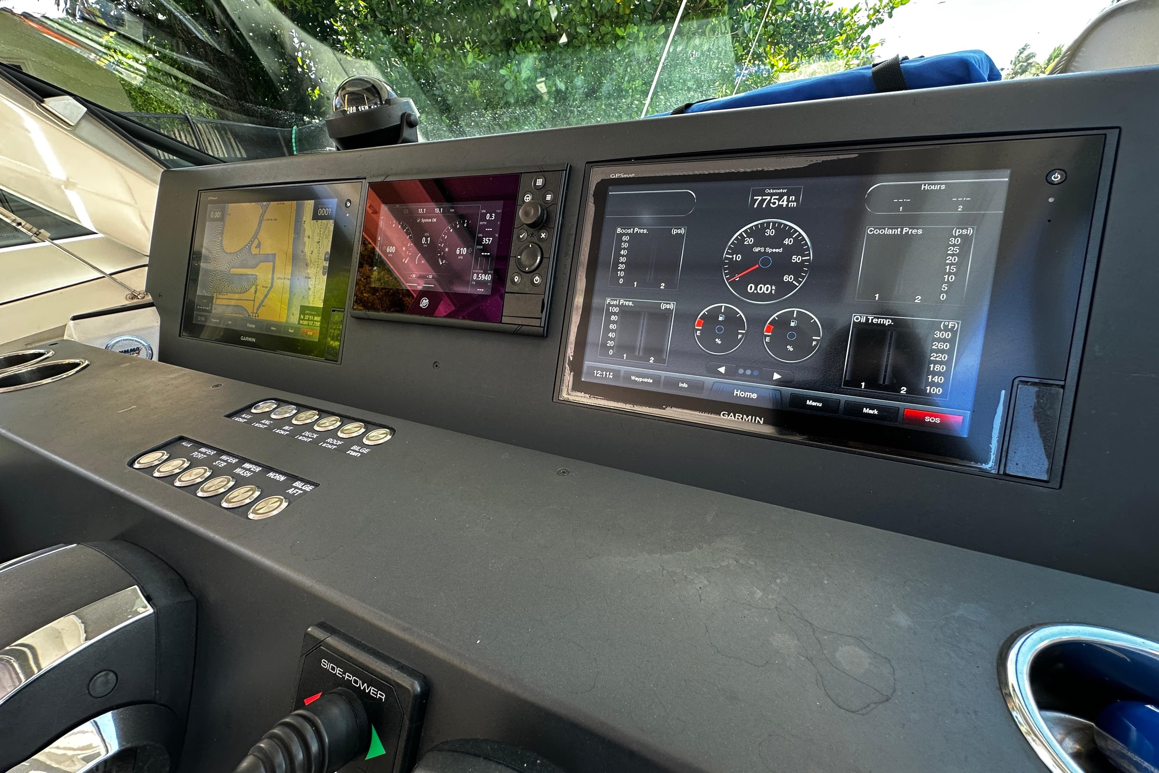 Dashboard of a 2018 Axopar 37 Sun-Top with navigation and control screens.