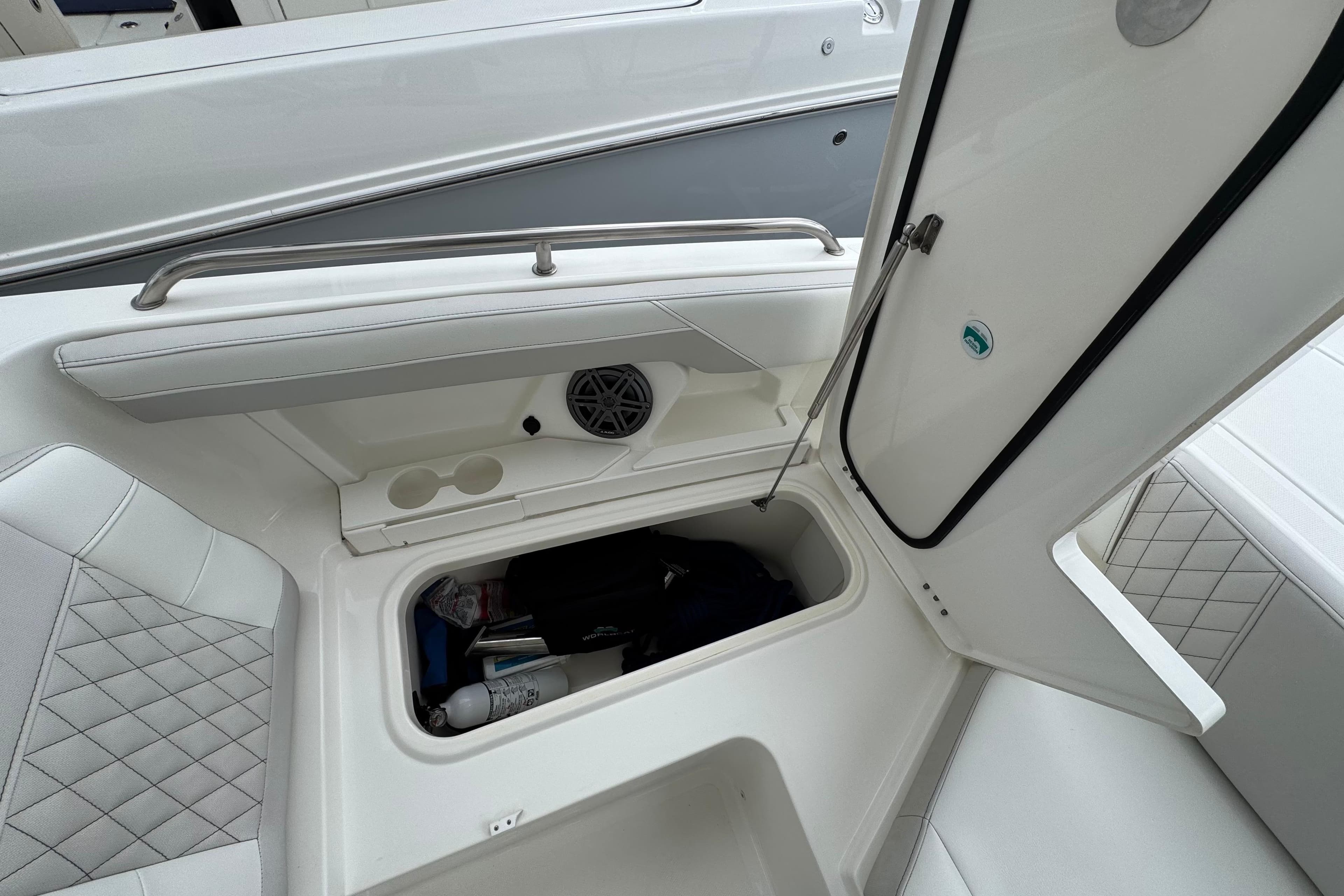 2024 World Cat 260 DC-X boat interior storage compartment open, showcasing spacious design.