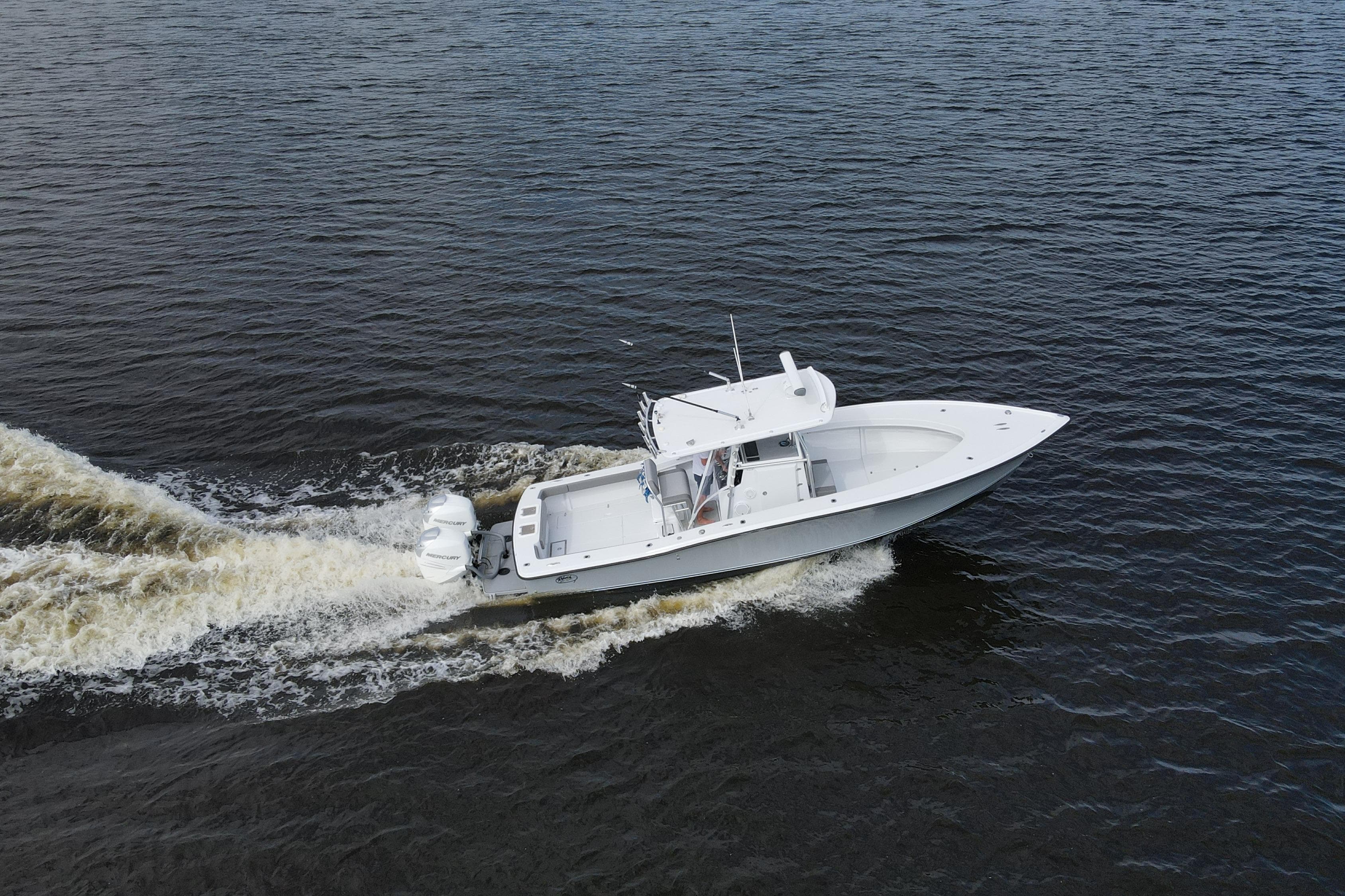 1984 Rybovich Rybo Runner boat cruising on open water, aerial view.