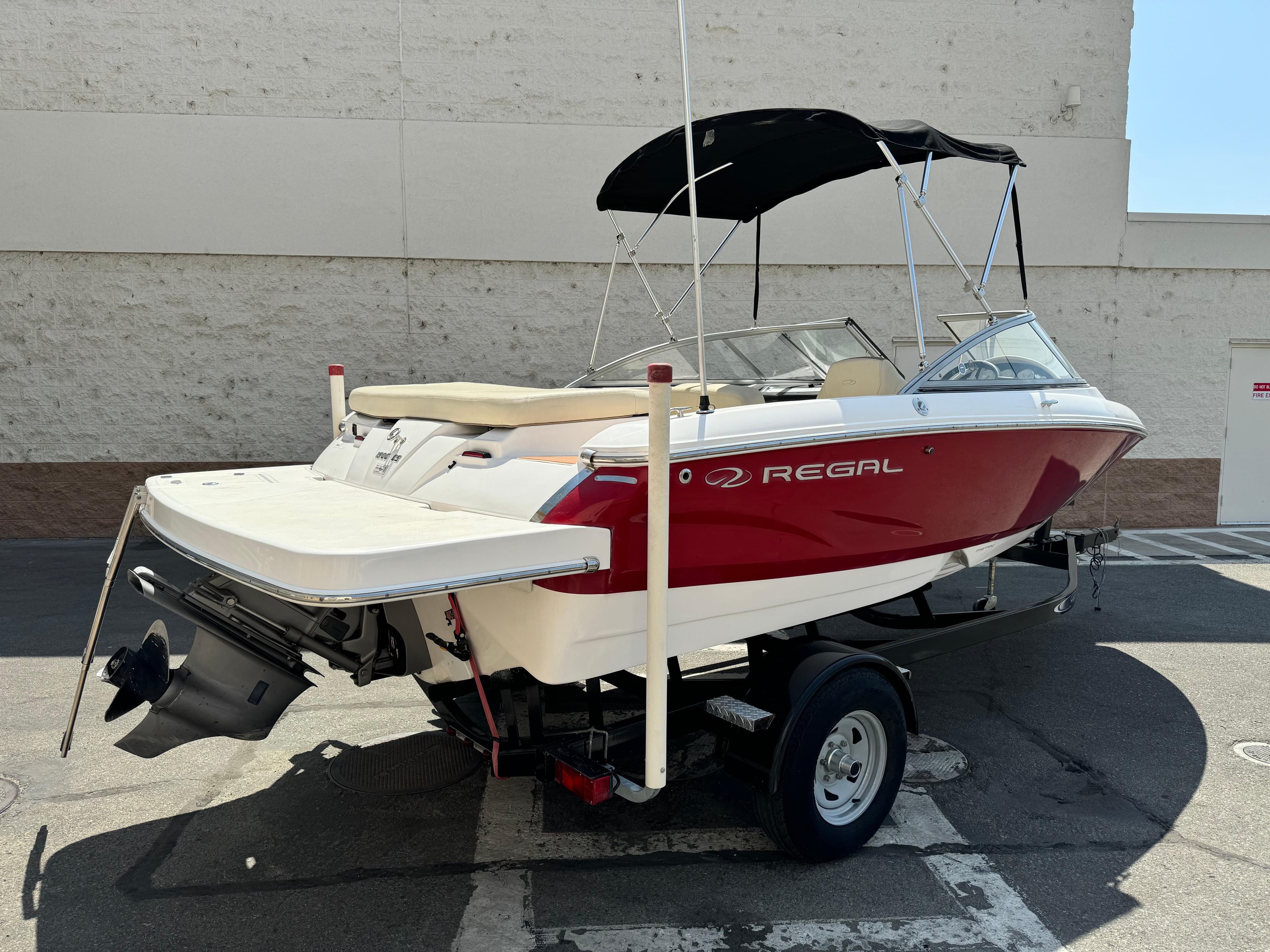 2019 Regal 1900 ES Bowrider boat with red and white exterior on a trailer.