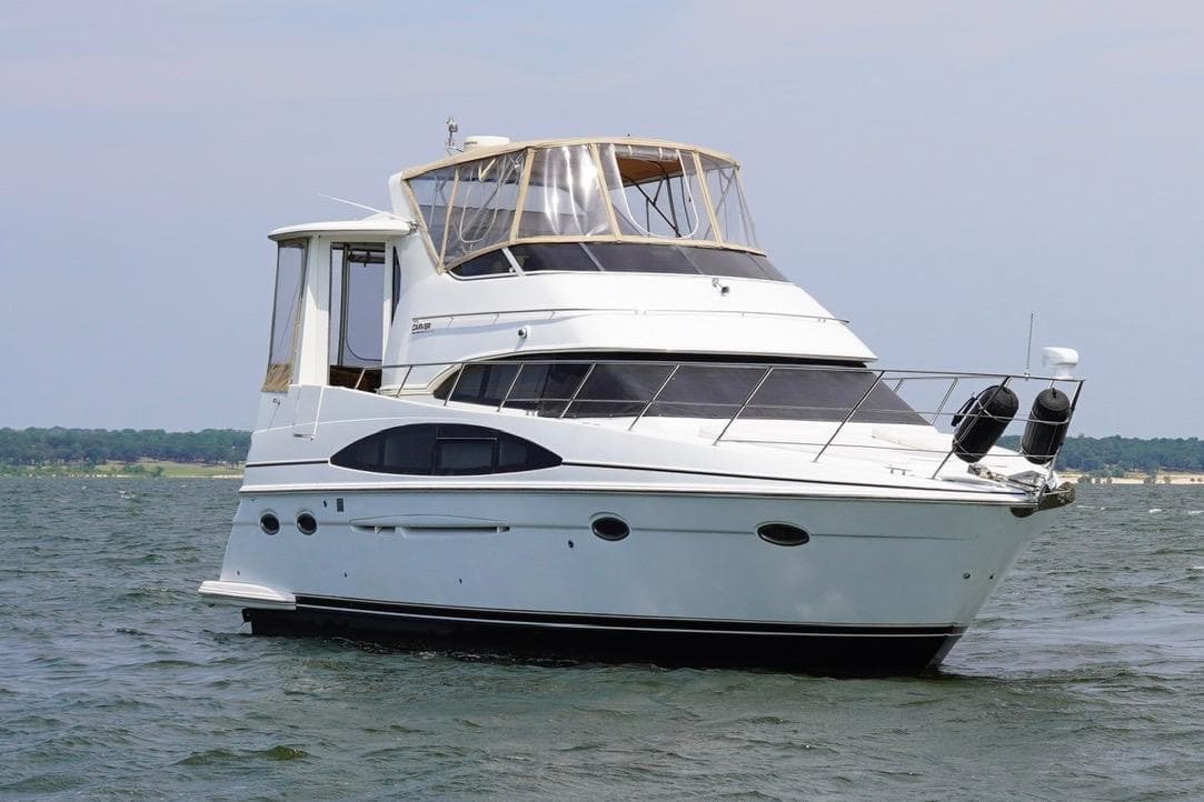 2003 Carver 396 Motor Yacht cruising on open water under a clear sky.