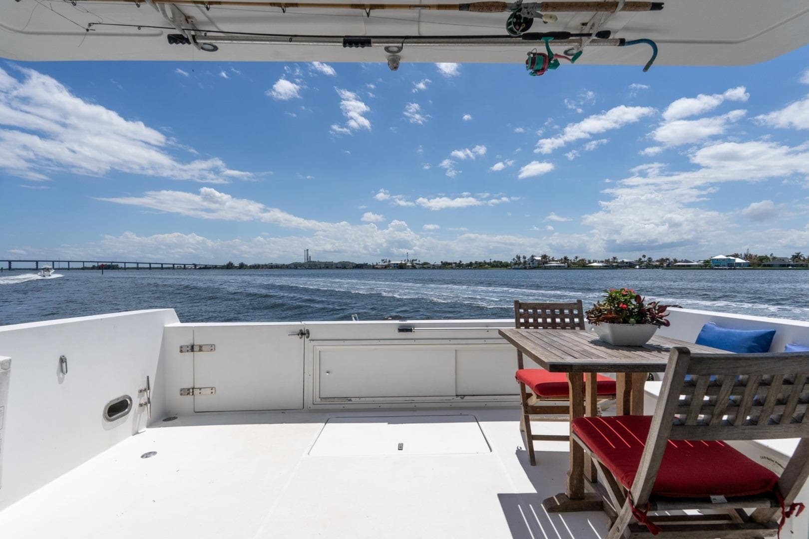 Deck view from 2003 Navigator 5700 yacht, featuring outdoor seating and ocean scenery.