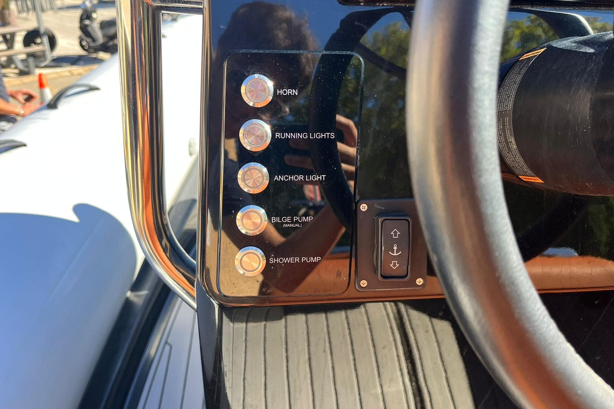 Control panel of 2022 Brig Eagle 6.7 boat with various switches and steering wheel.