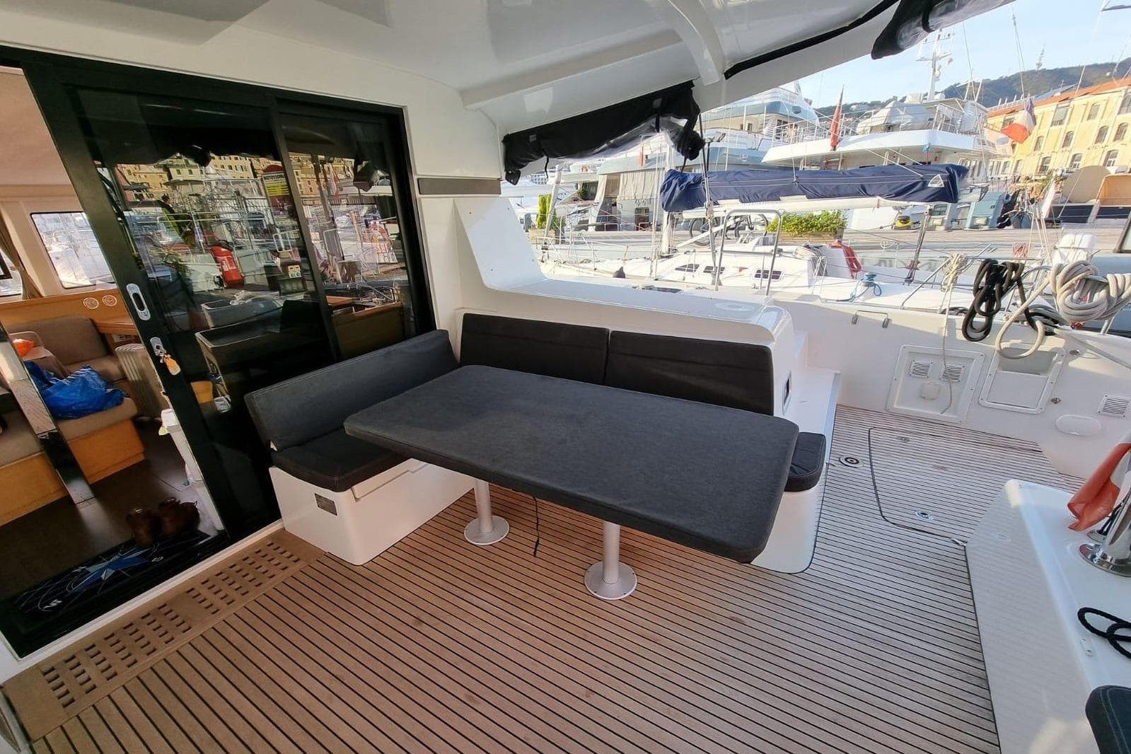 2017 Lagoon 42 yacht cockpit with seating and table, docked at marina.