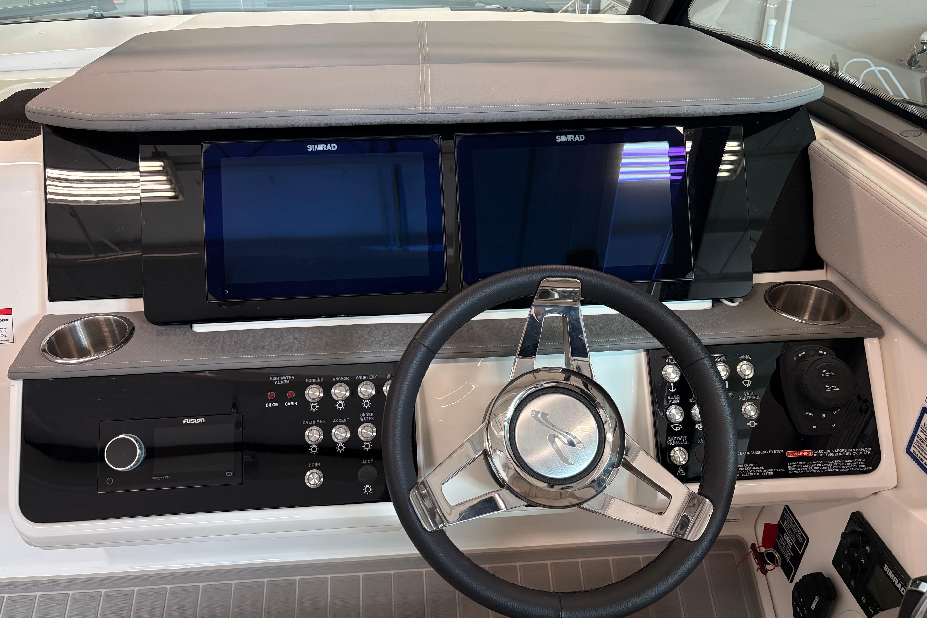 2026 Sea Ray Sundancer 320 helm with dual Simrad displays and modern controls.
