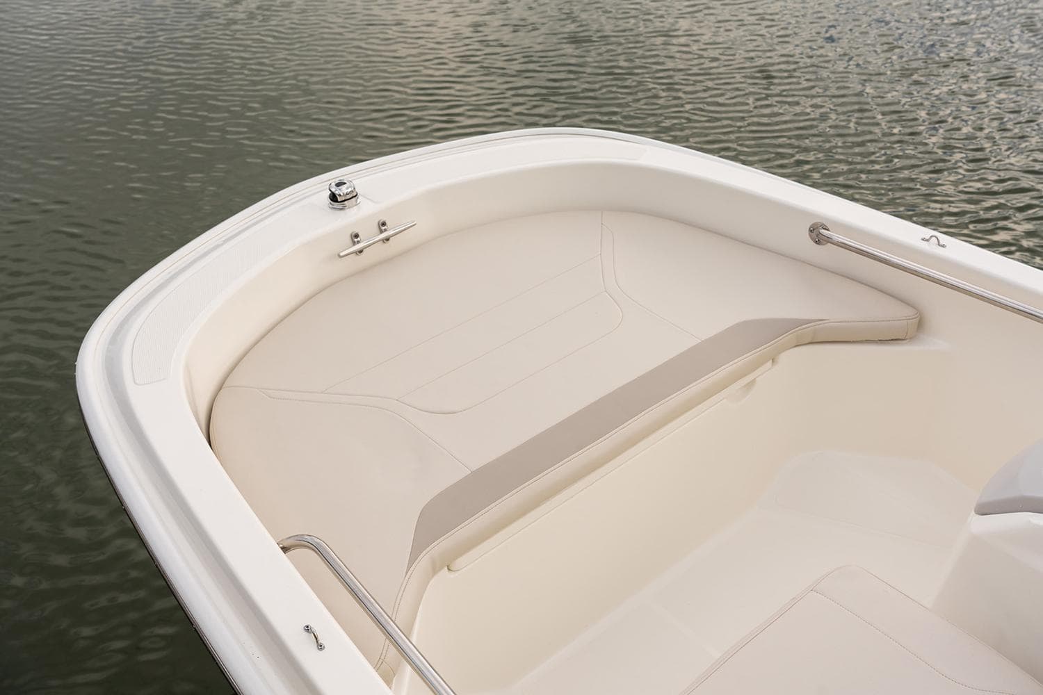 Manufacturer Provided Image: 2025 Boston Whaler 130 Super Sport boat interior, featuring sleek seating and railing on calm water.