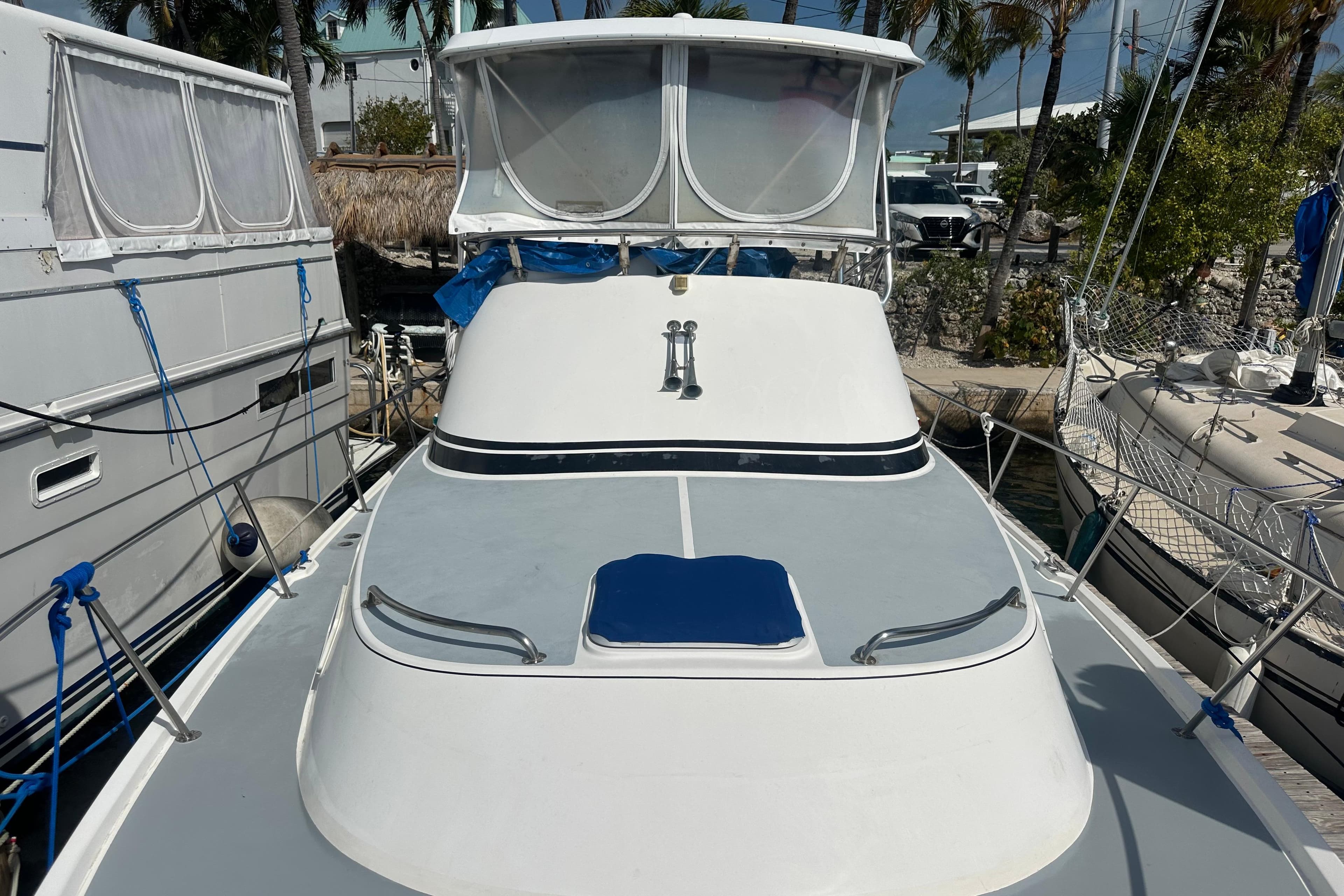 1991 Carver Californian 48 yacht docked, featuring sleek design and spacious deck.