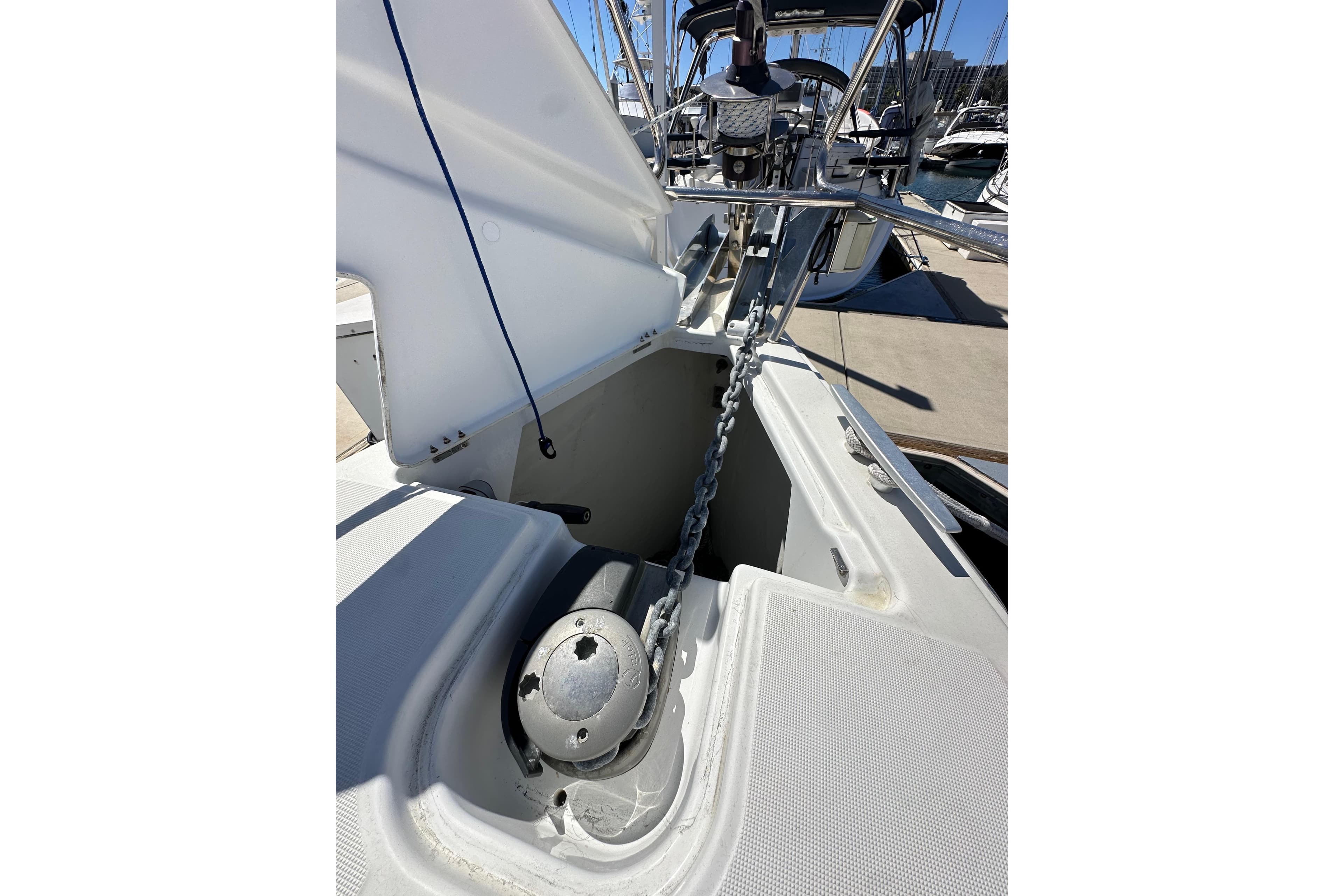 2015 Jeanneau Sun Odyssey 409 anchor chain and windlass in marina setting.
