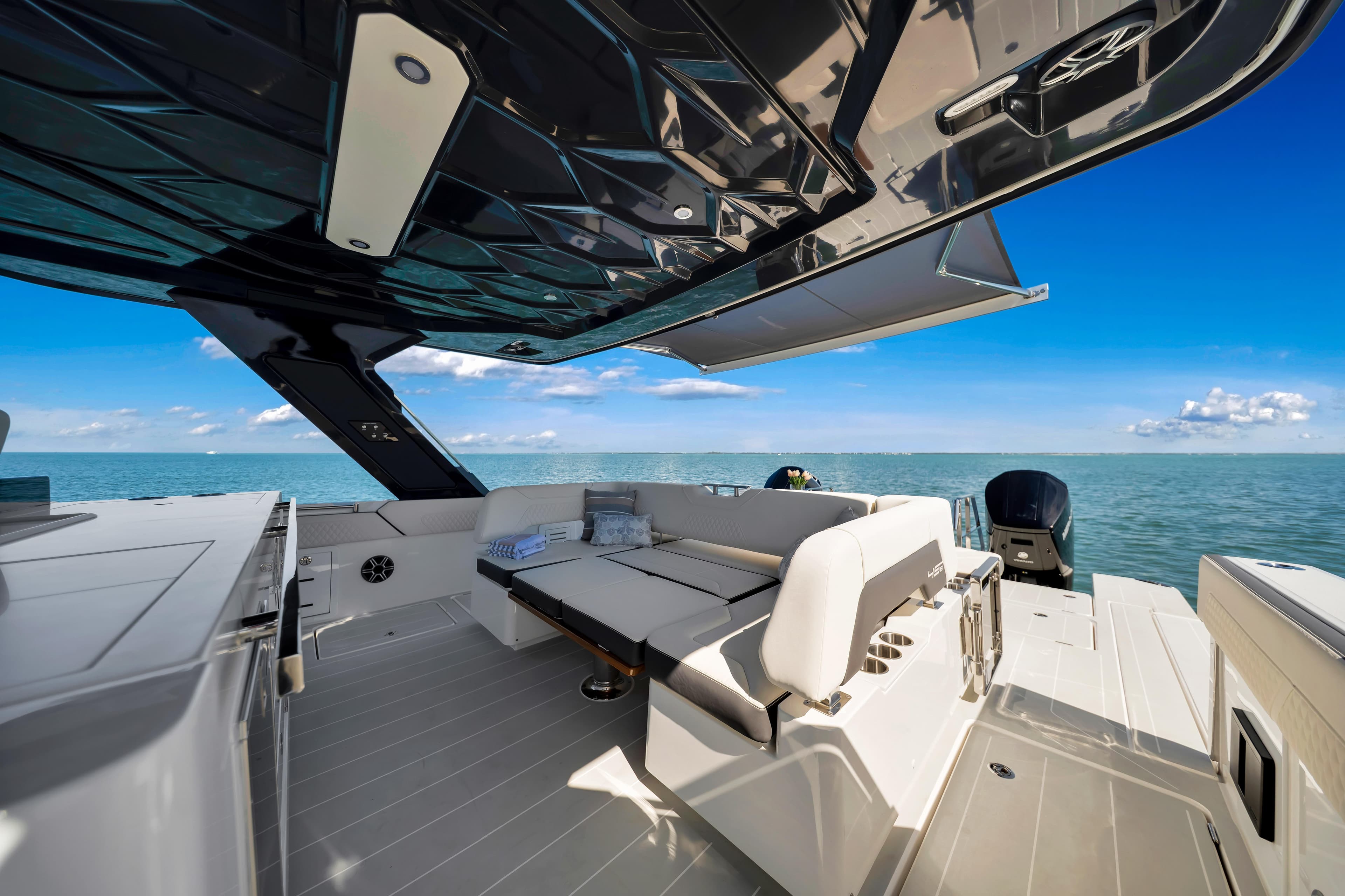 Luxurious 2026 Aquila 45 Sport yacht interior with sleek seating and ocean view.