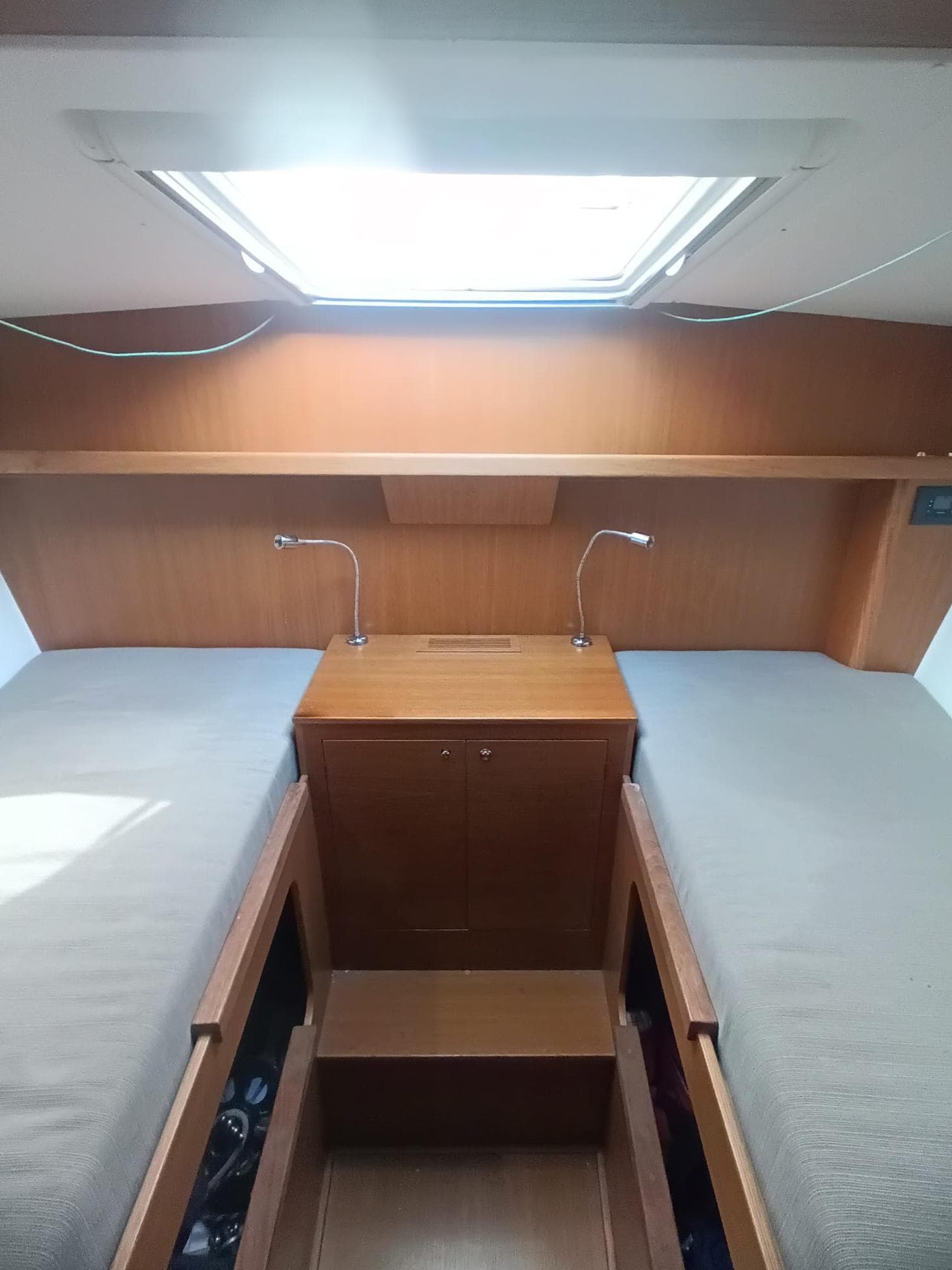 Interior of 2020 Comar Comet 62 RS yacht cabin with twin beds and reading lights.