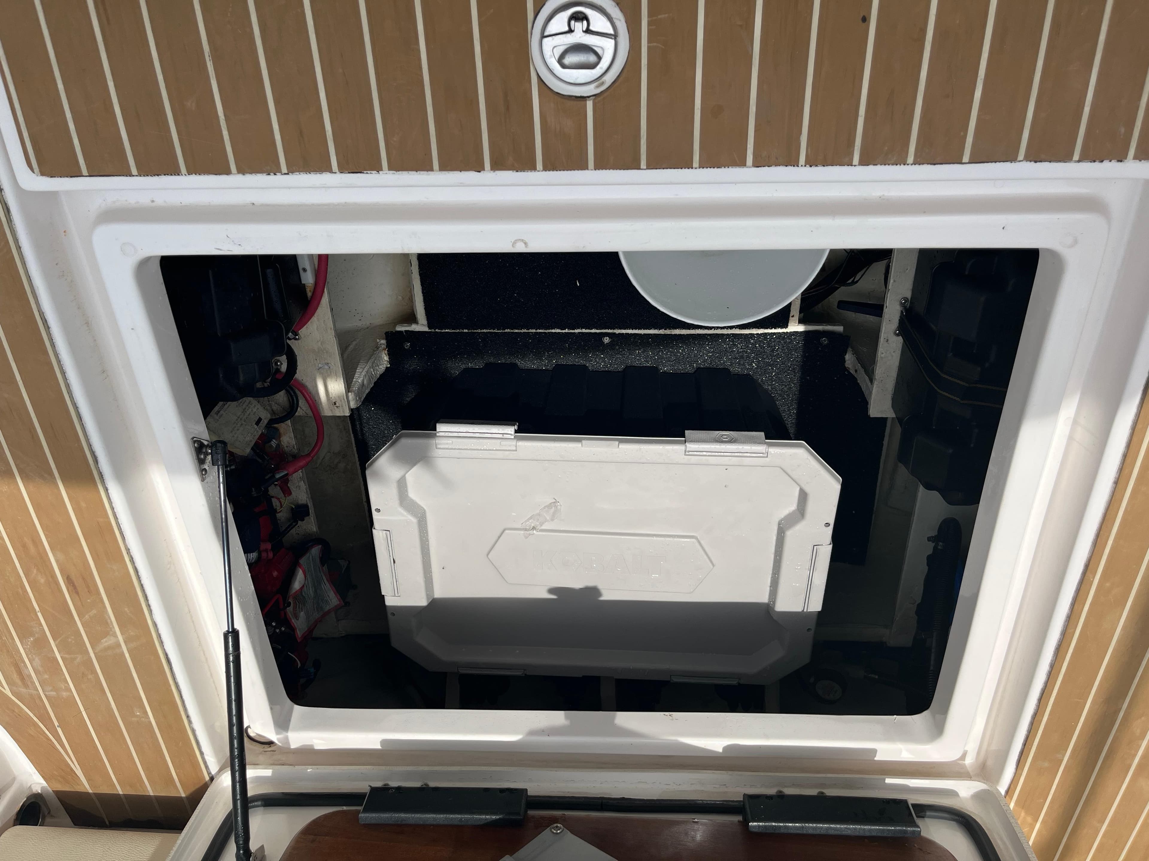 2019 Regal 33 SAV boat storage compartment with open hatch and visible equipment.