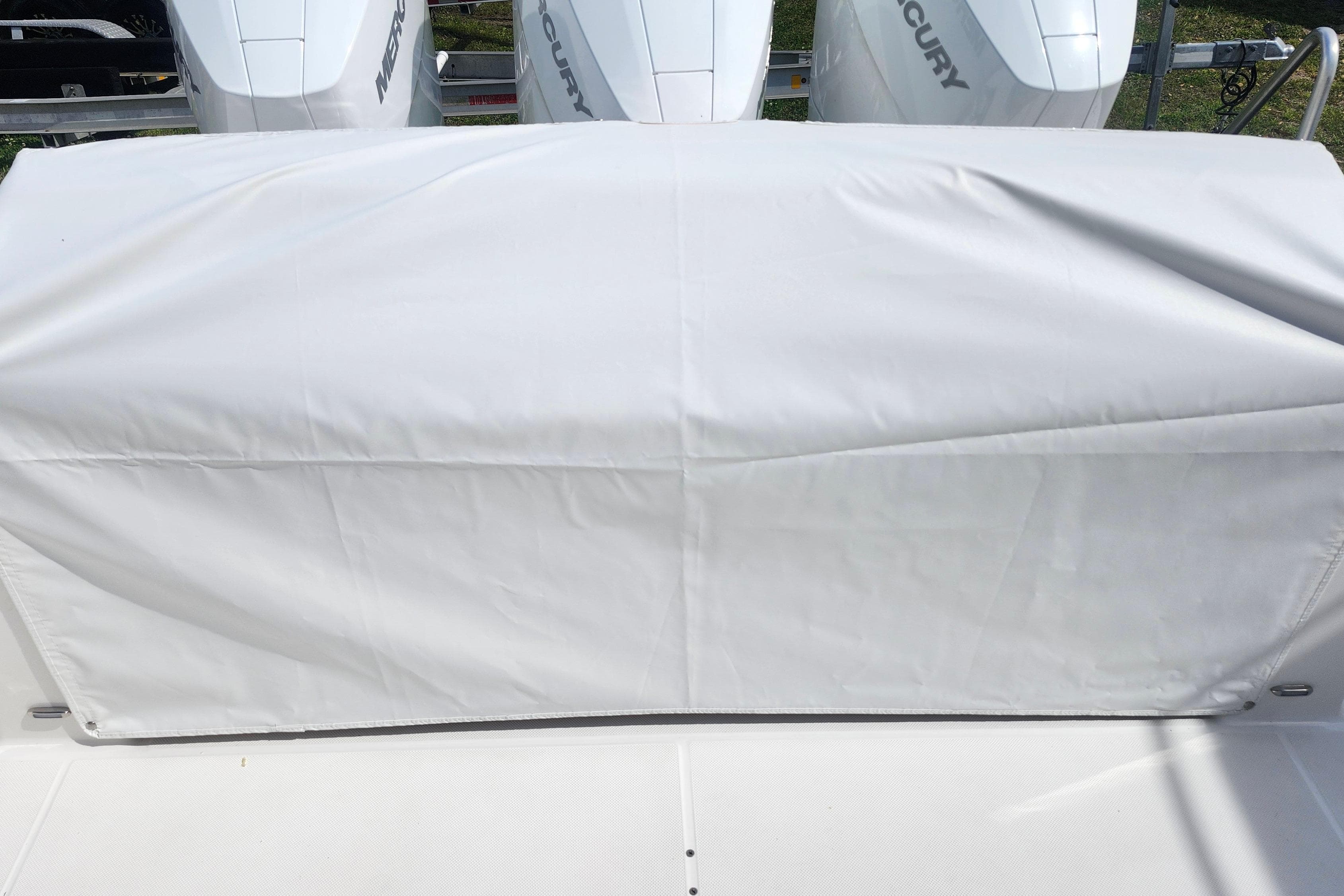 Covered area on a 2026 Regal 38 SAV boat with Mercury engines visible.