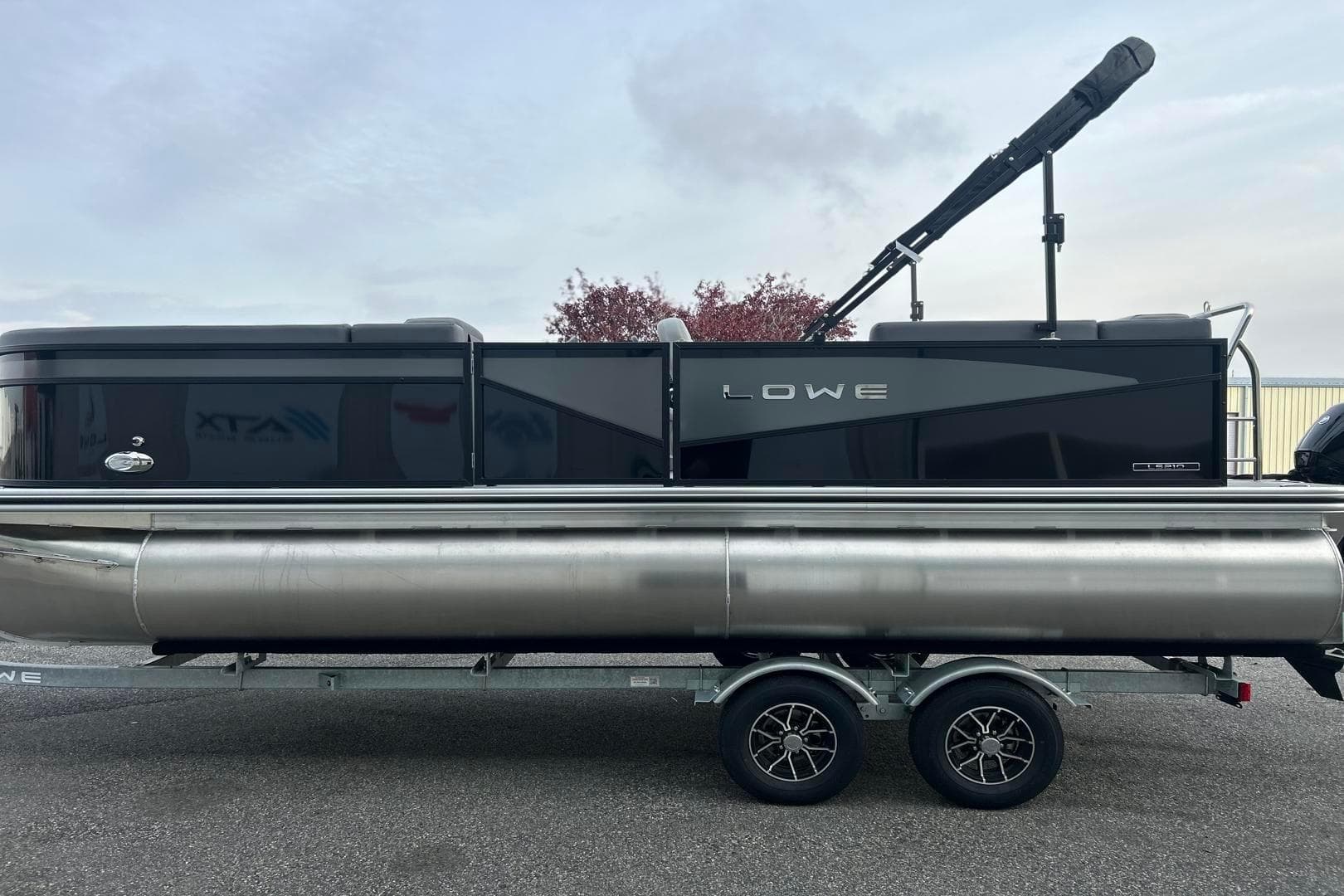 2026 Lowe LS 210 WT pontoon boat on trailer, sleek black design.