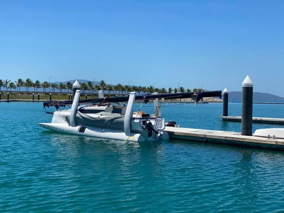2025 Corsair 880 trimaran docked in a sunny marina.