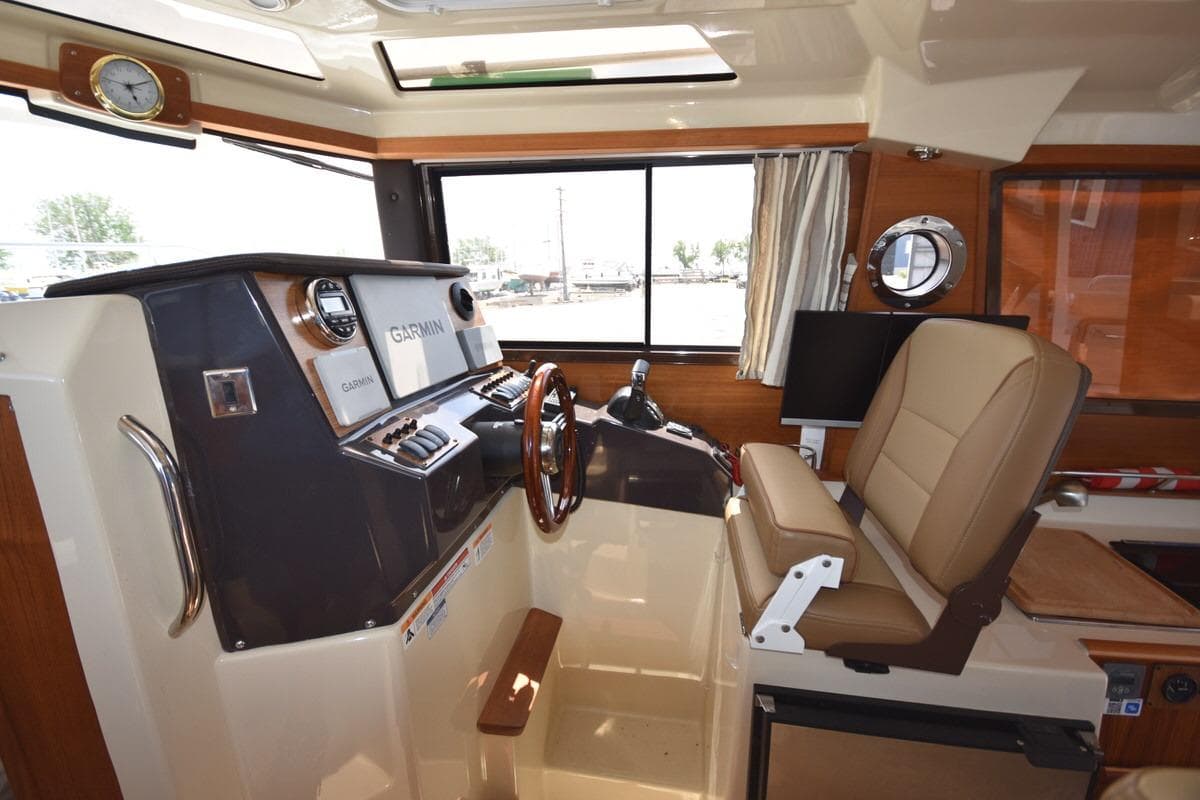 Interior of 2024 Ranger Tugs R-25 boat with helm and navigation equipment.