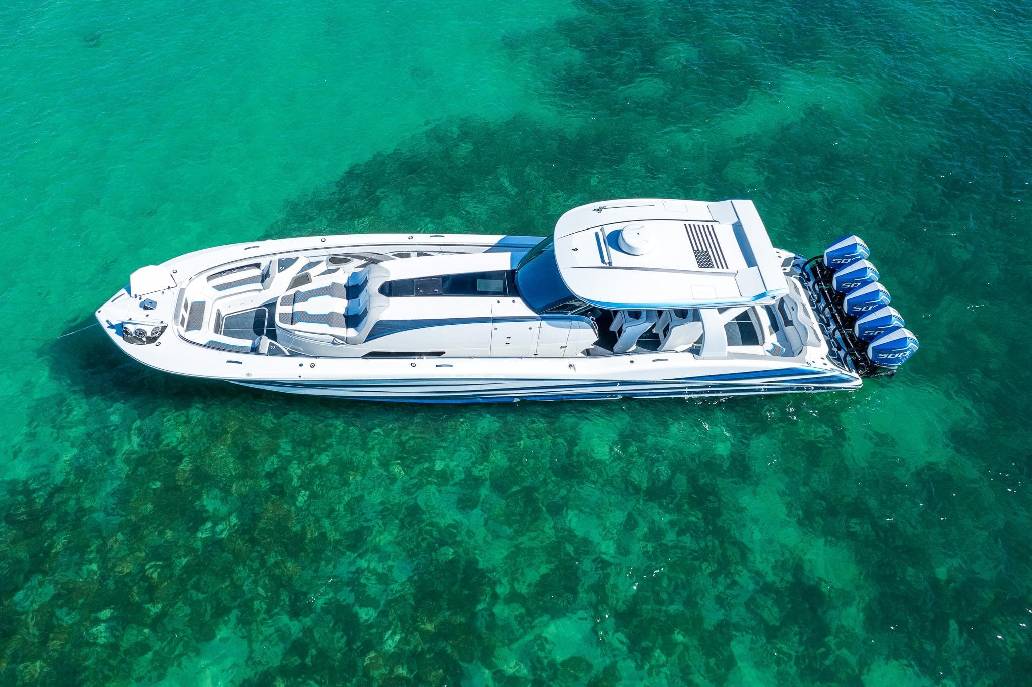 Aerial view of 2023 MTI 50v boat on clear turquoise water.