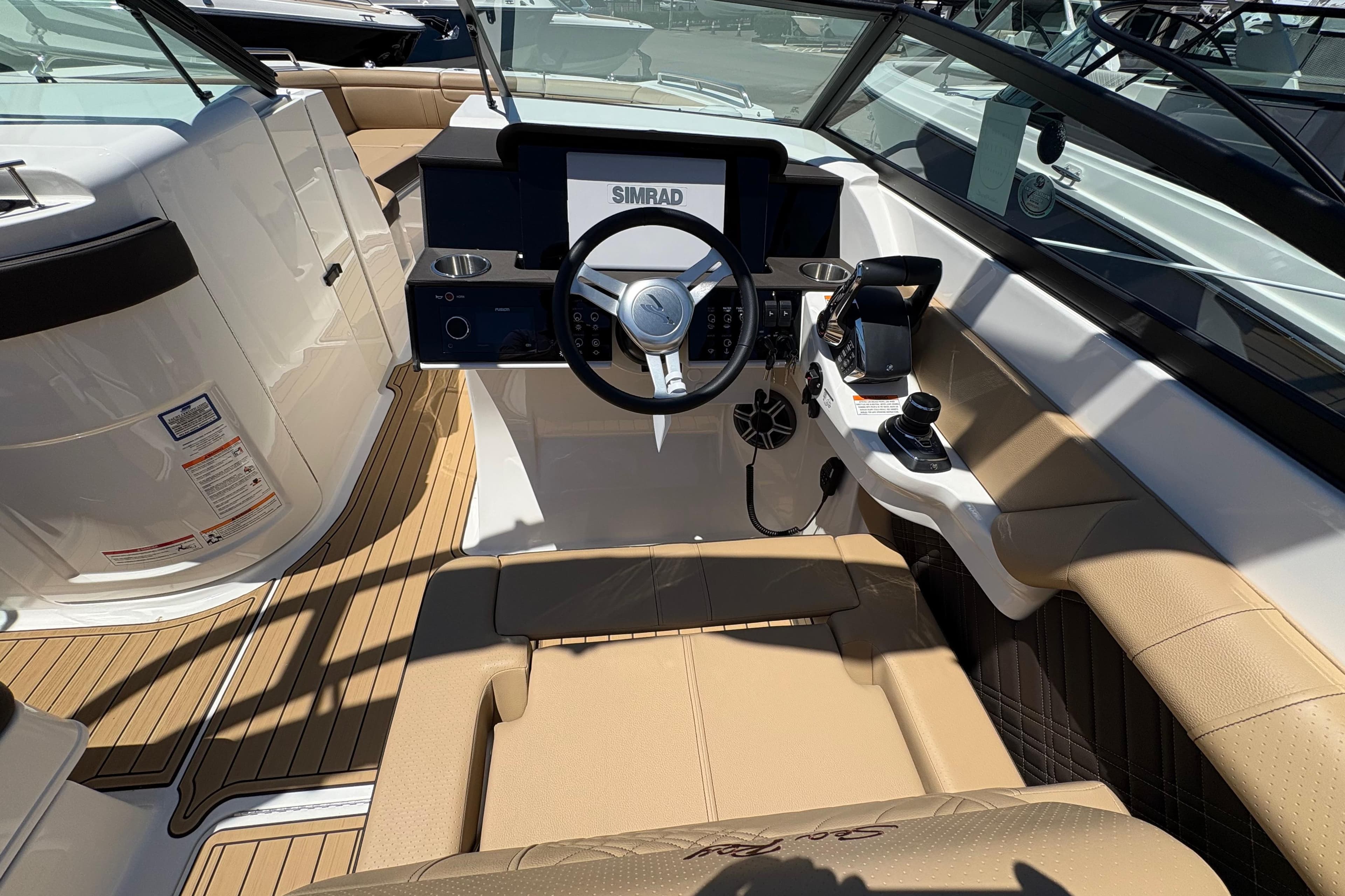 2026 Sea Ray SDX 290 Outboard boat interior with steering wheel and control panel.