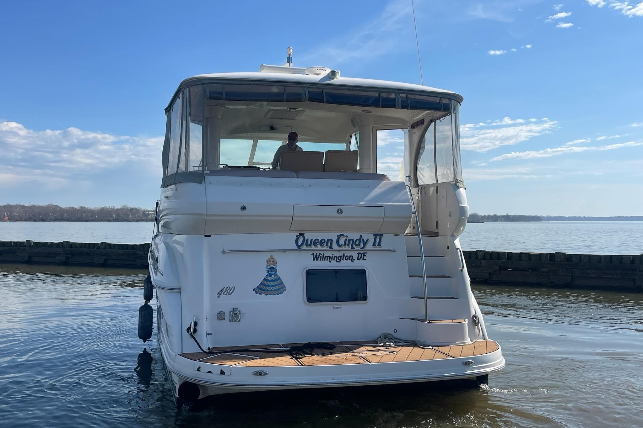 2004 Sea Ray 480 Motor Yacht docked, rear view with clear skies.
