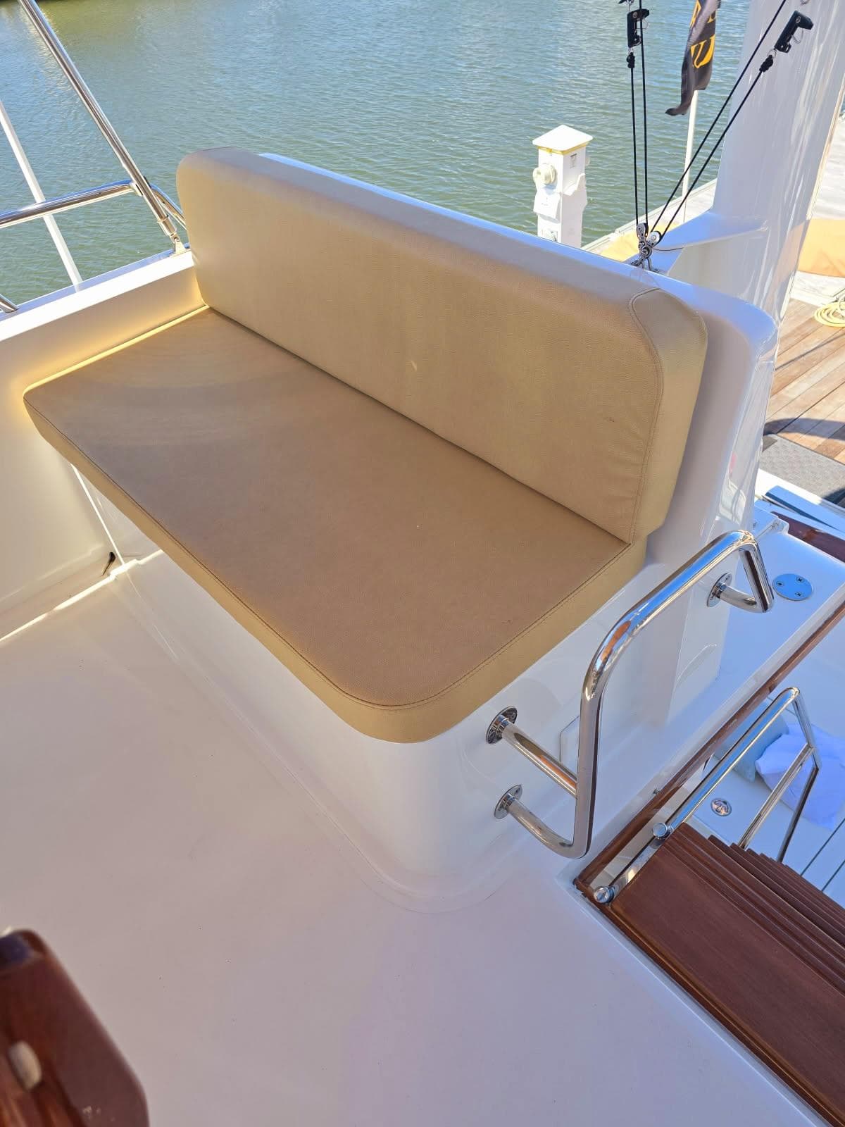 2004 Sabre 36 Flybridge Fast Trawler with cushioned seating on deck.
