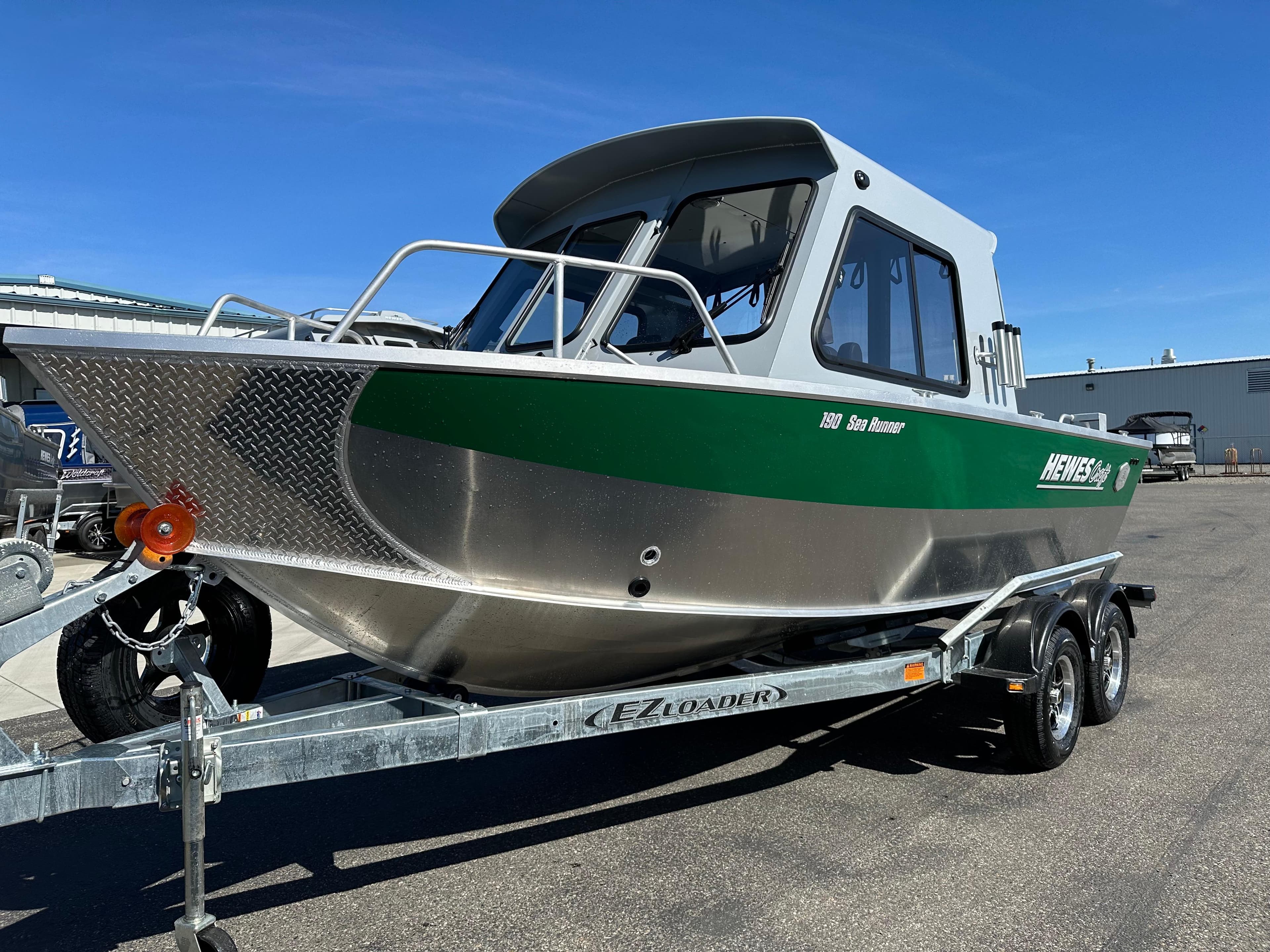 2024 Hewescraft 190 Searunner HT FC boat on trailer, green and silver exterior.
