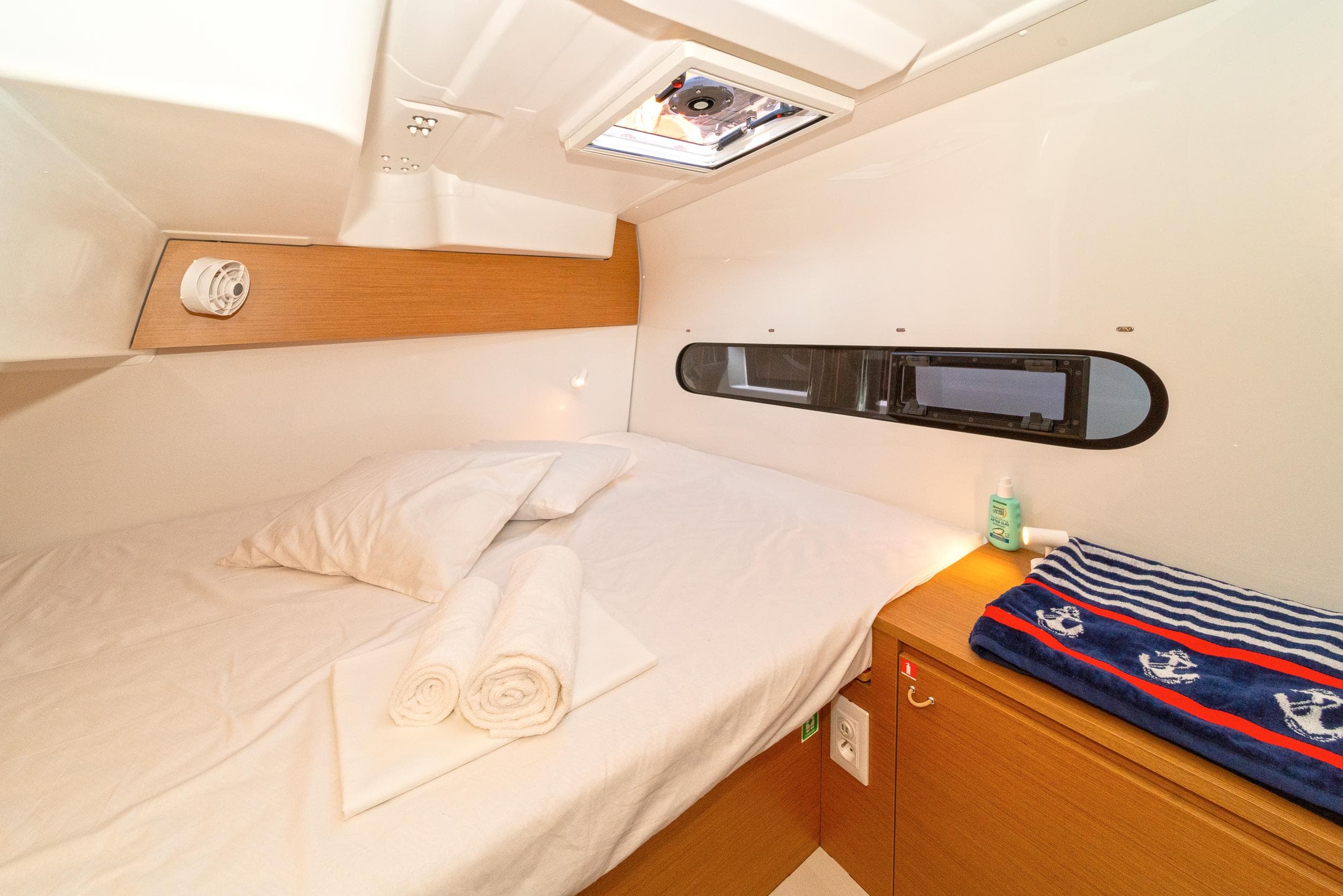 Cozy cabin interior of 2023 Excess 11 yacht with bed and nautical decor.