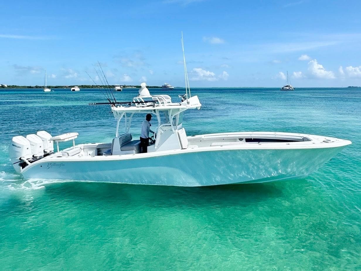 2021 Yellowfin 36 Offshore boat cruising in clear turquoise waters under a blue sky.
