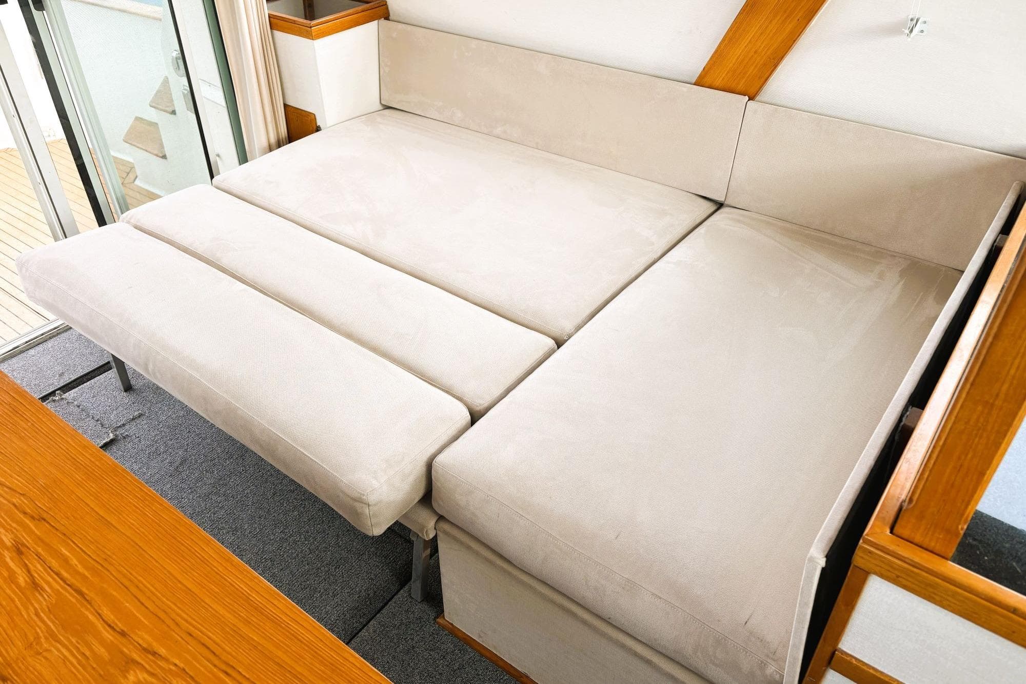 1980 Tollycraft 34 Sedan interior with beige convertible sofa bed.