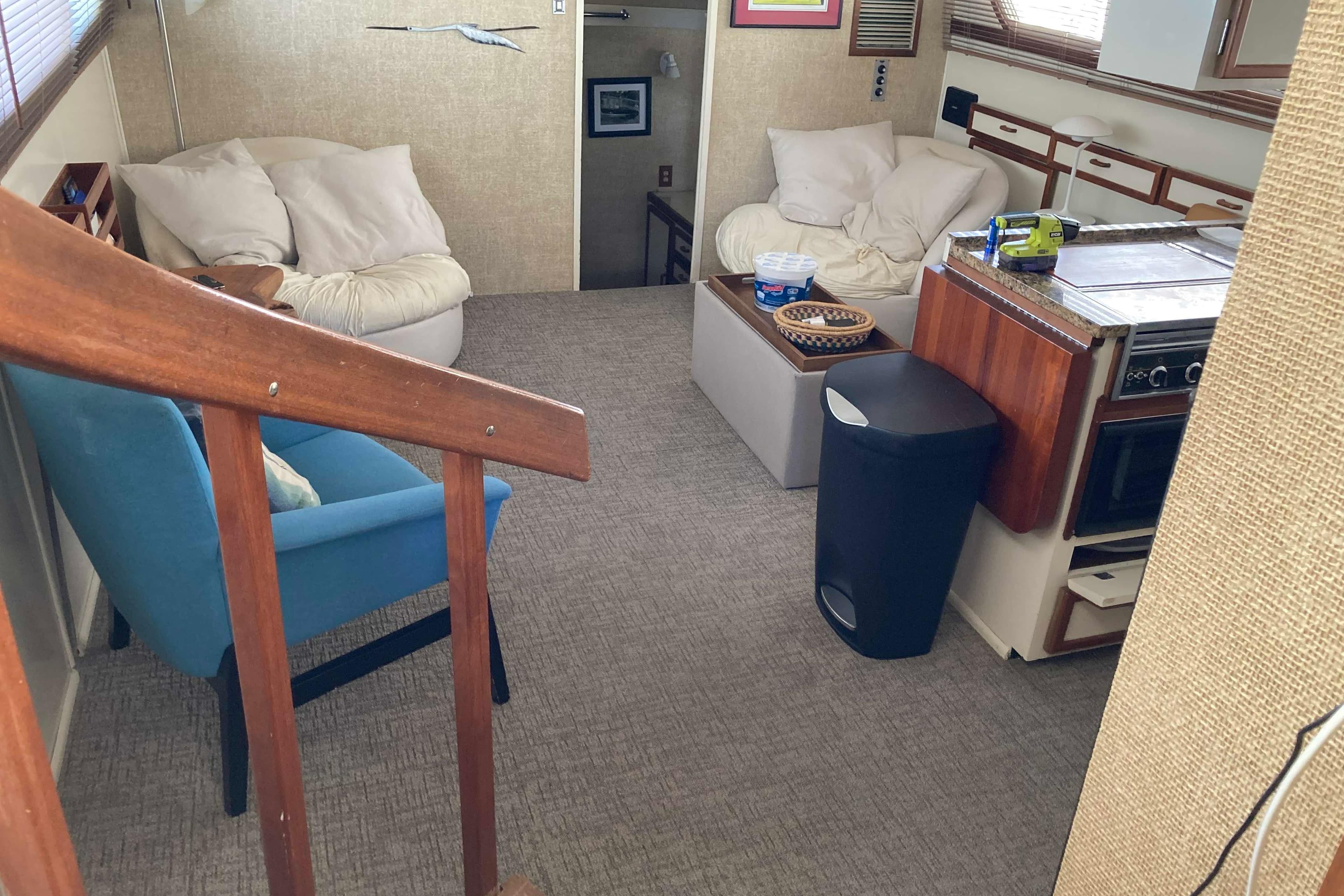 Interior of 1972 Chris-Craft 45 Commander yacht with cozy seating and kitchen area.
