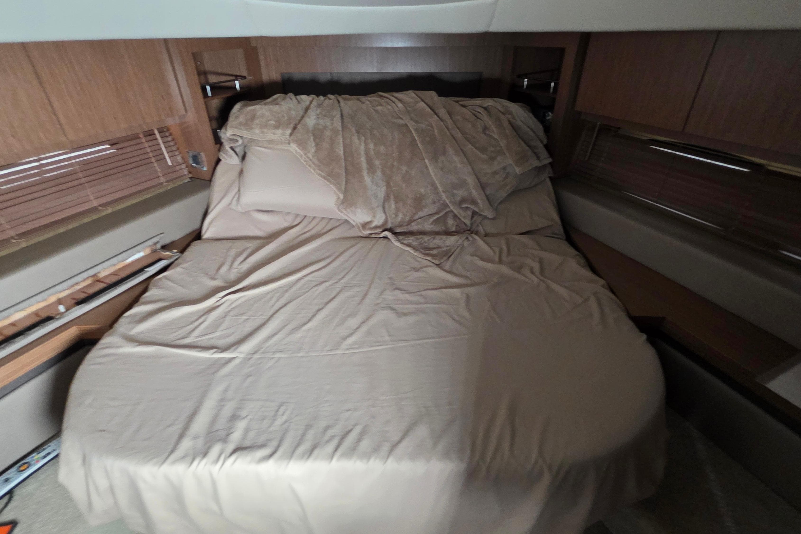 Luxurious cabin interior of 2018 Sea Ray Sundancer 510 yacht with cozy bed.