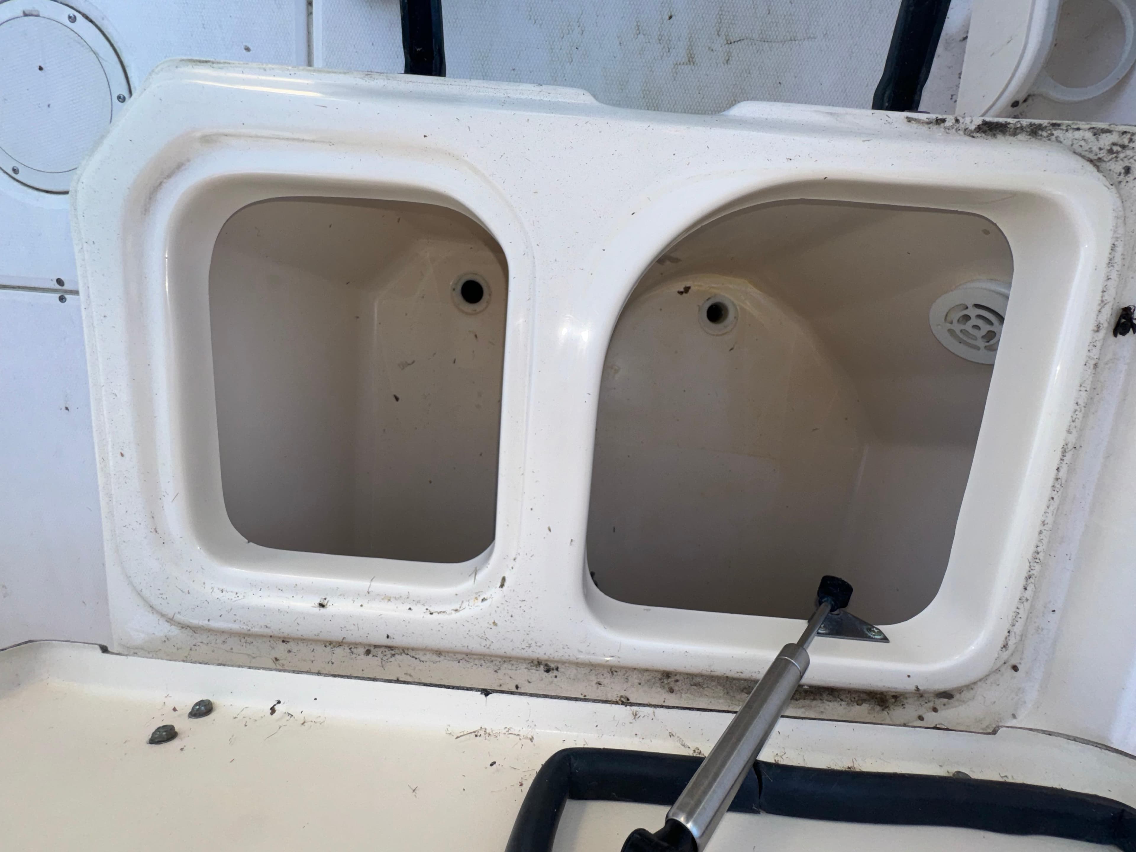 2006 Grady-White Seafarer 226 boat with two empty storage compartments.