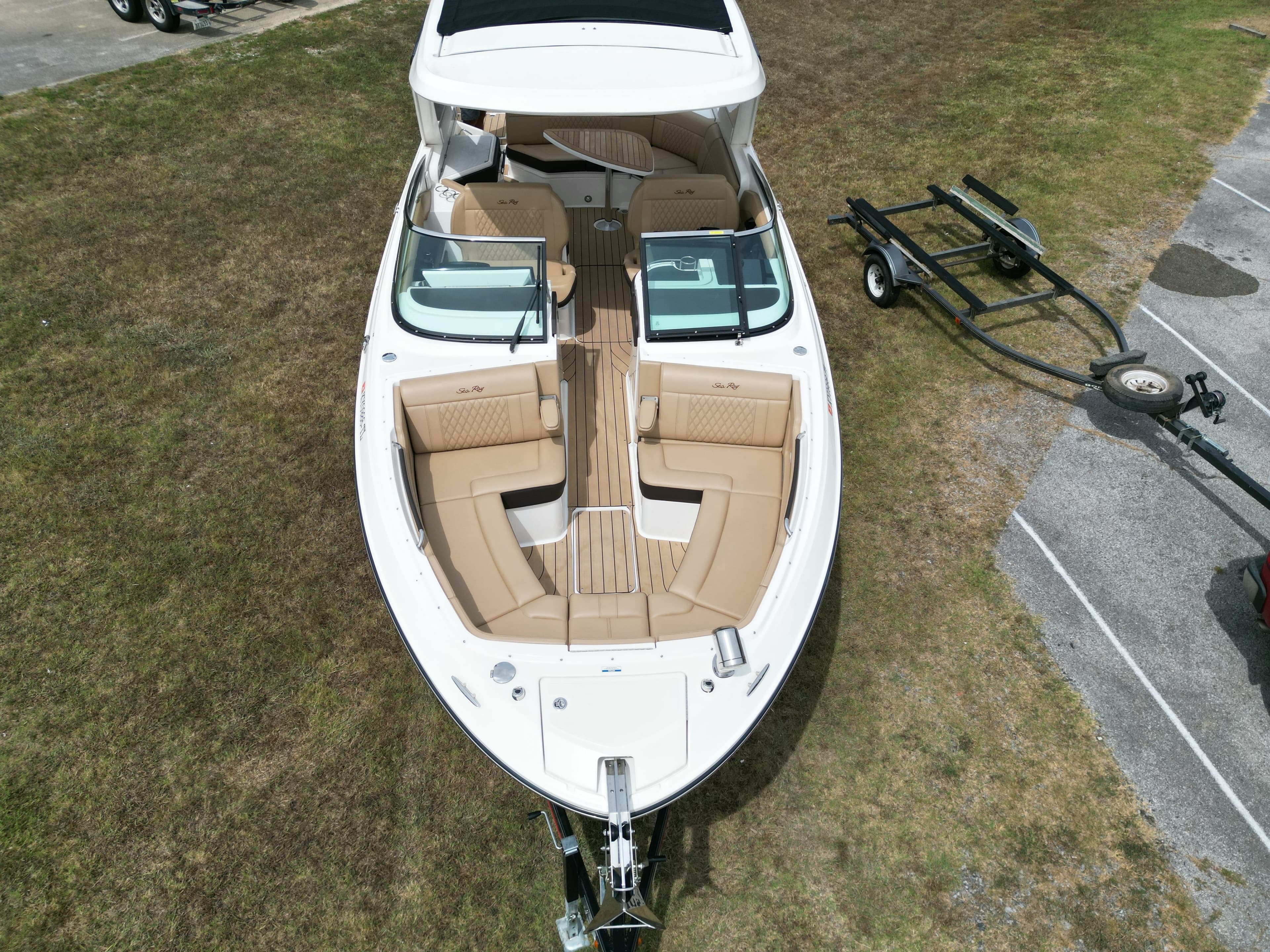2022 Sea Ray SLX 310 boat on grass with trailer, aerial view.