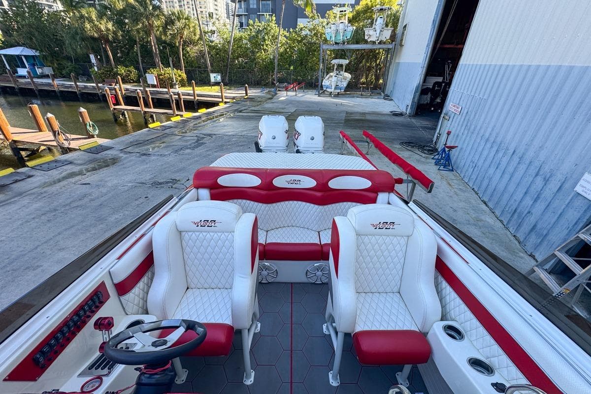 2022 Velocity 290sc boat interior with red and white seating, dockside view.