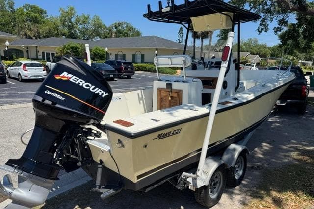 1987 Mako 232 Center Console boat with Mercury Optimax engine on trailer.