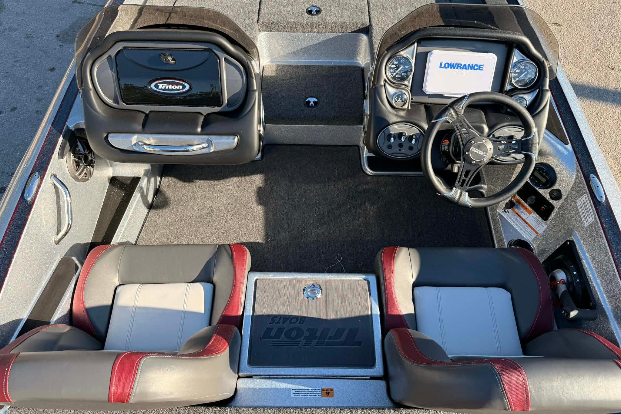 2026 Triton 179 TrX boat interior with steering wheel, seats, and control panel.