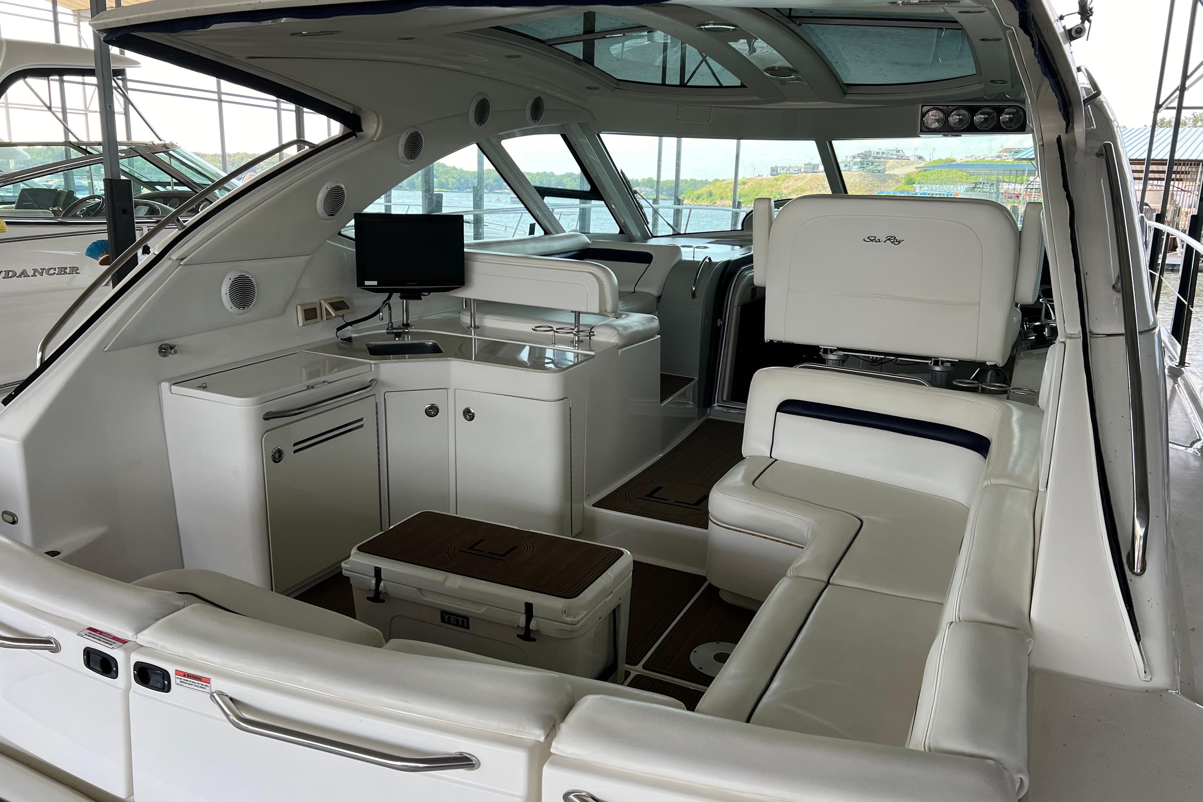 Luxurious interior of 2009 Searay 470 Sundancer yacht with white seating and modern amenities.