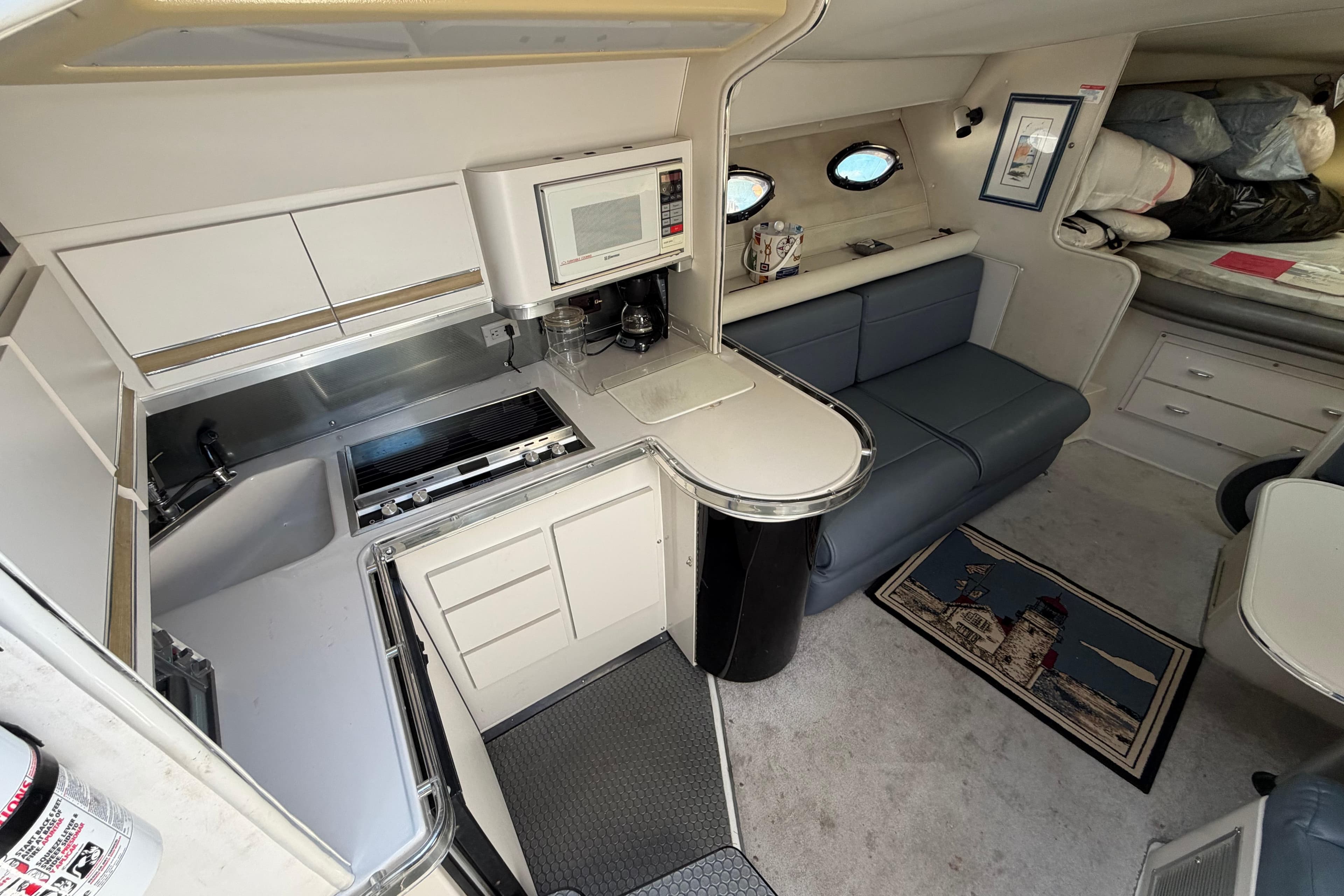 Interior of 1989 Wellcraft 3400 Gran Sport yacht with kitchenette and seating area.