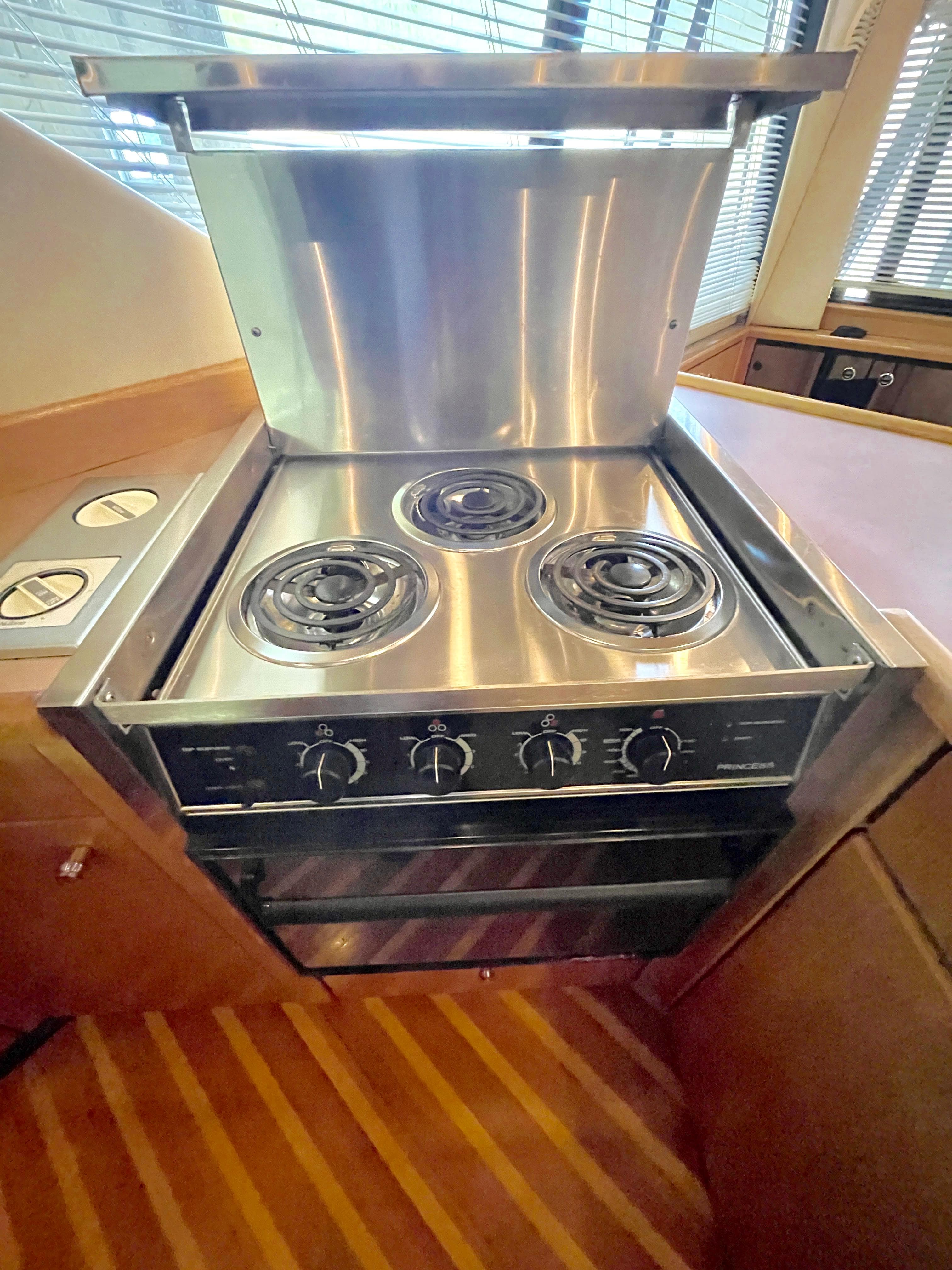 Stainless steel stove in 1998 Bayliner 3988 Command Bridge Motoryacht kitchen.
