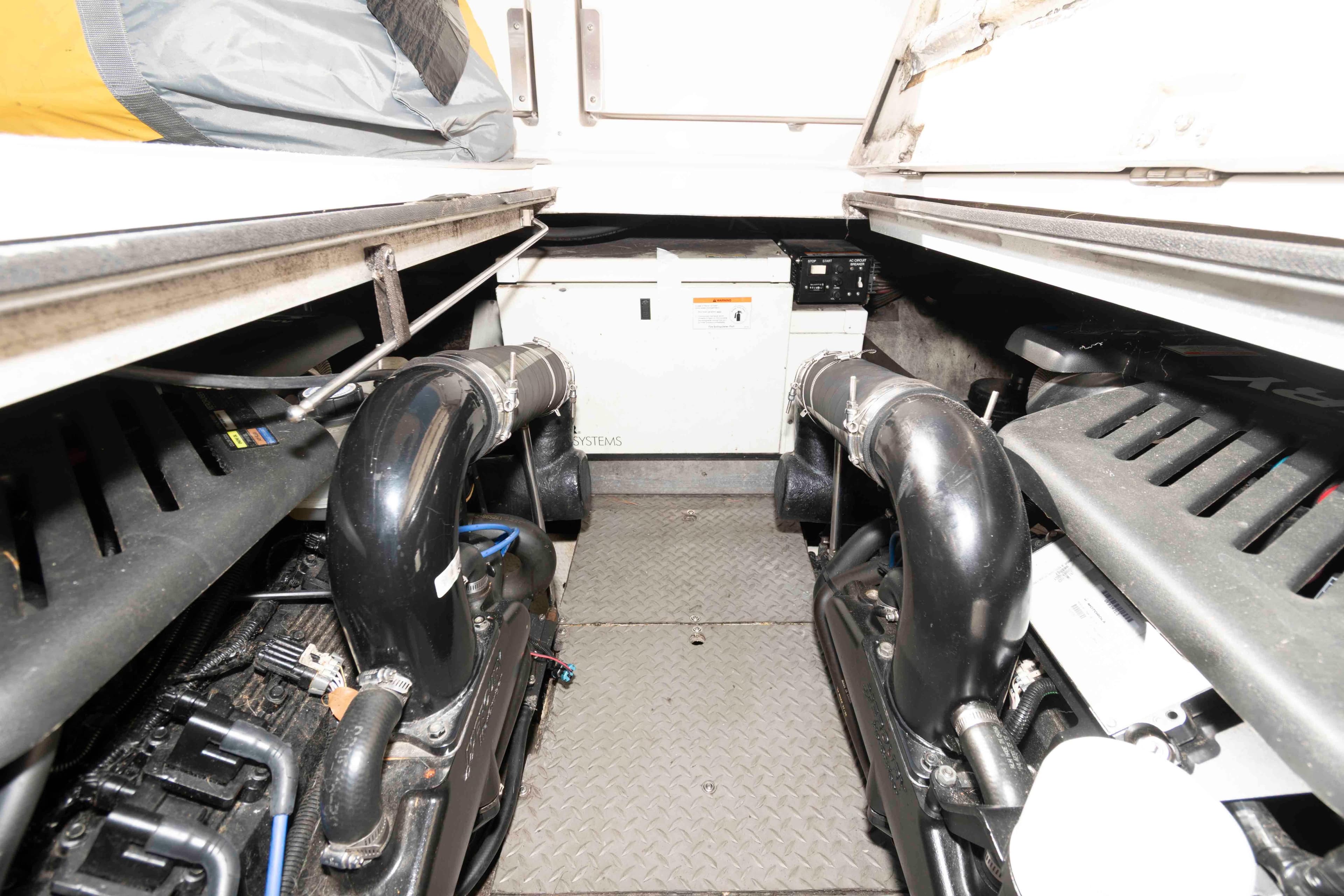 Engine room of a 2005 Regal Commodore 3880 boat, showcasing dual engines and equipment.