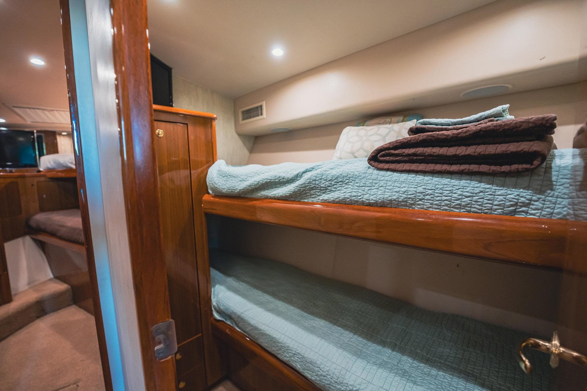 2005 Viking 48 Convertible yacht interior with cozy bunk beds and wooden finishes.