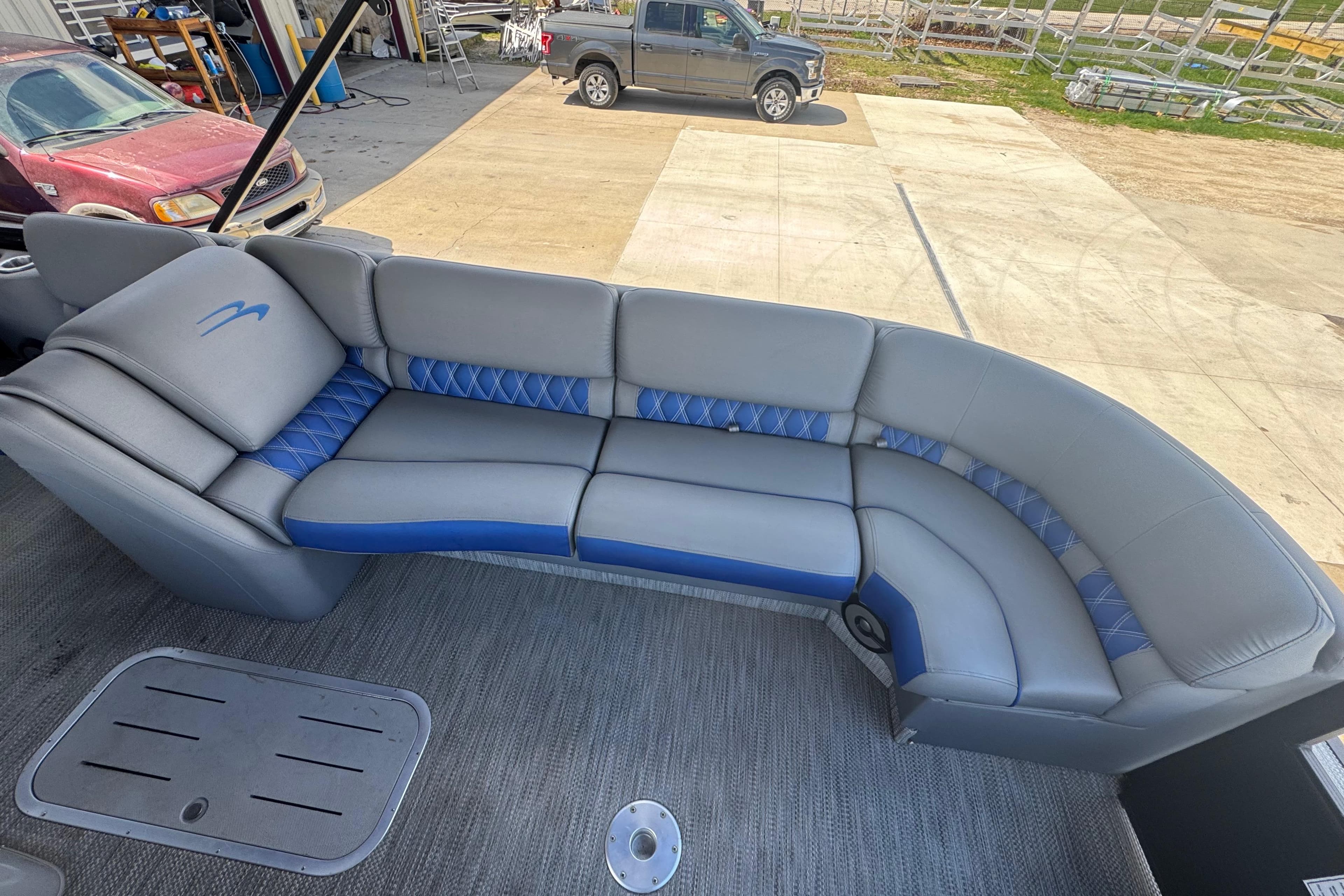 2020 Bennington R 25 RFB boat interior with gray and blue seating.