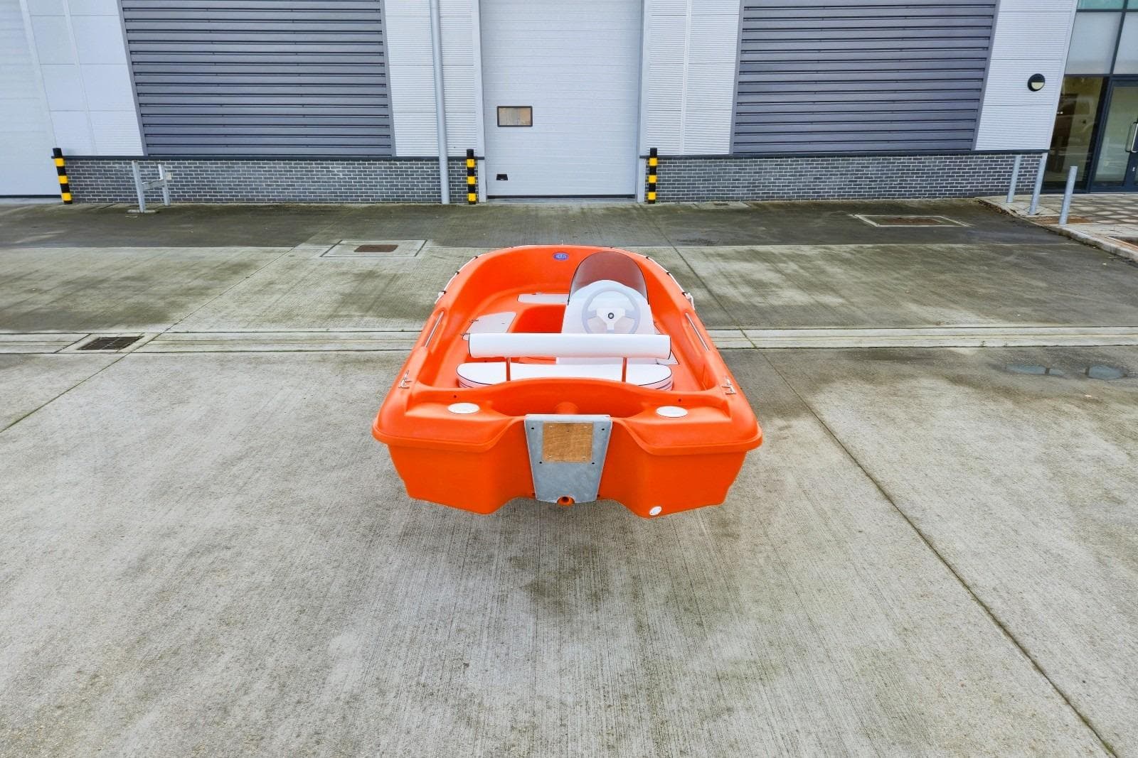 Orange Rigiflex New Matic 400 boat, 2025 model, parked on concrete surface.