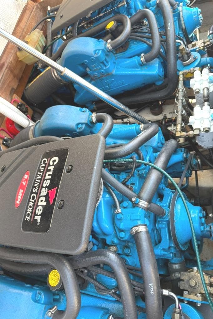 Twin Crusader engines in a 1986 Dusky 26 Custom boat, showcasing blue engine components.
