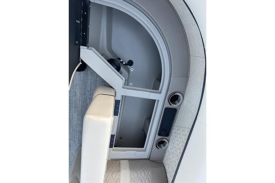 Interior view of 2026 Bennington M Quad Bench 22 MFB, featuring storage compartment and seating.