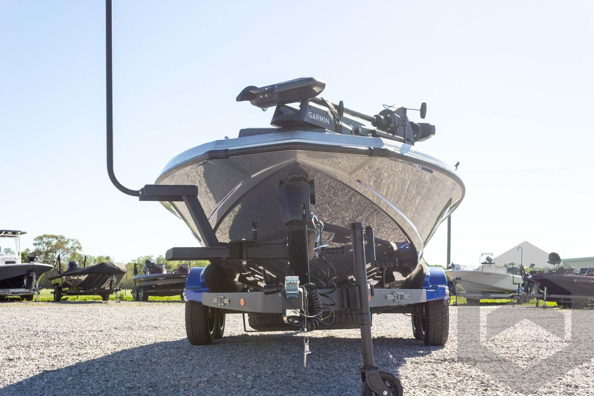 2026 Vexus VXs21 boat on trailer, featuring Garmin equipment, parked outdoors.