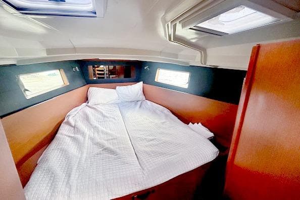 Cozy cabin interior of 2017 Beneteau Oceanis 41.1 sailboat with comfortable bedding.