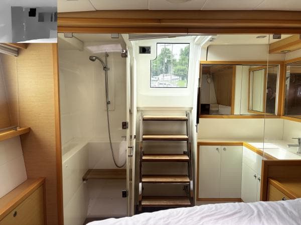 Luxurious Lagoon 560 yacht interior, featuring a modern bathroom and wooden accents, 2012 model.