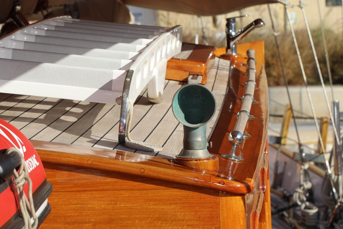 Classic 1933 Camper & Nicholsons wooden ketch deck with polished wood and nautical details.