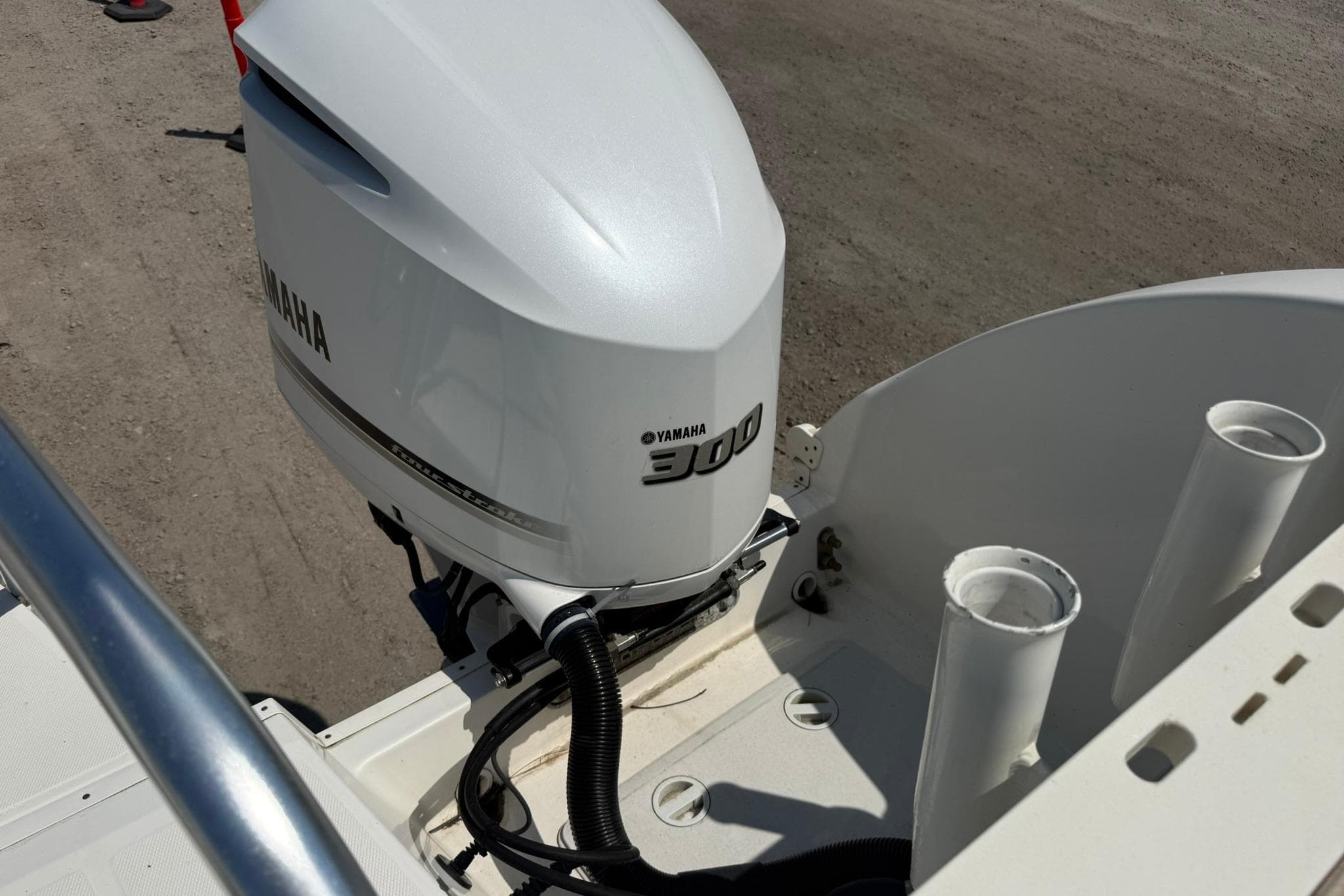 Yamaha 300 outboard motor on 2020 World Cat 325 CC boat, docked on sandy ground.